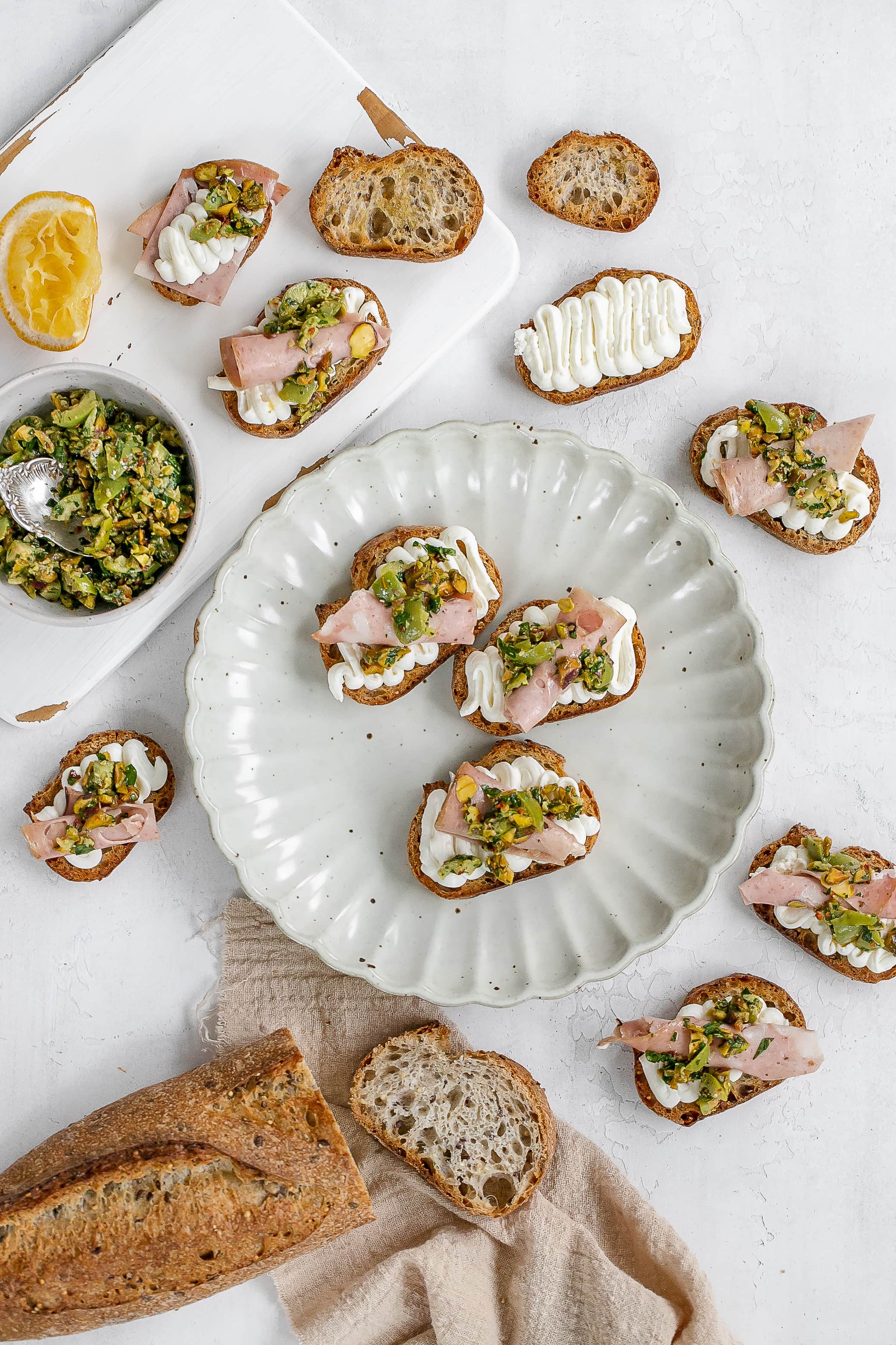 whipped ricotta on a crostini on a plate.