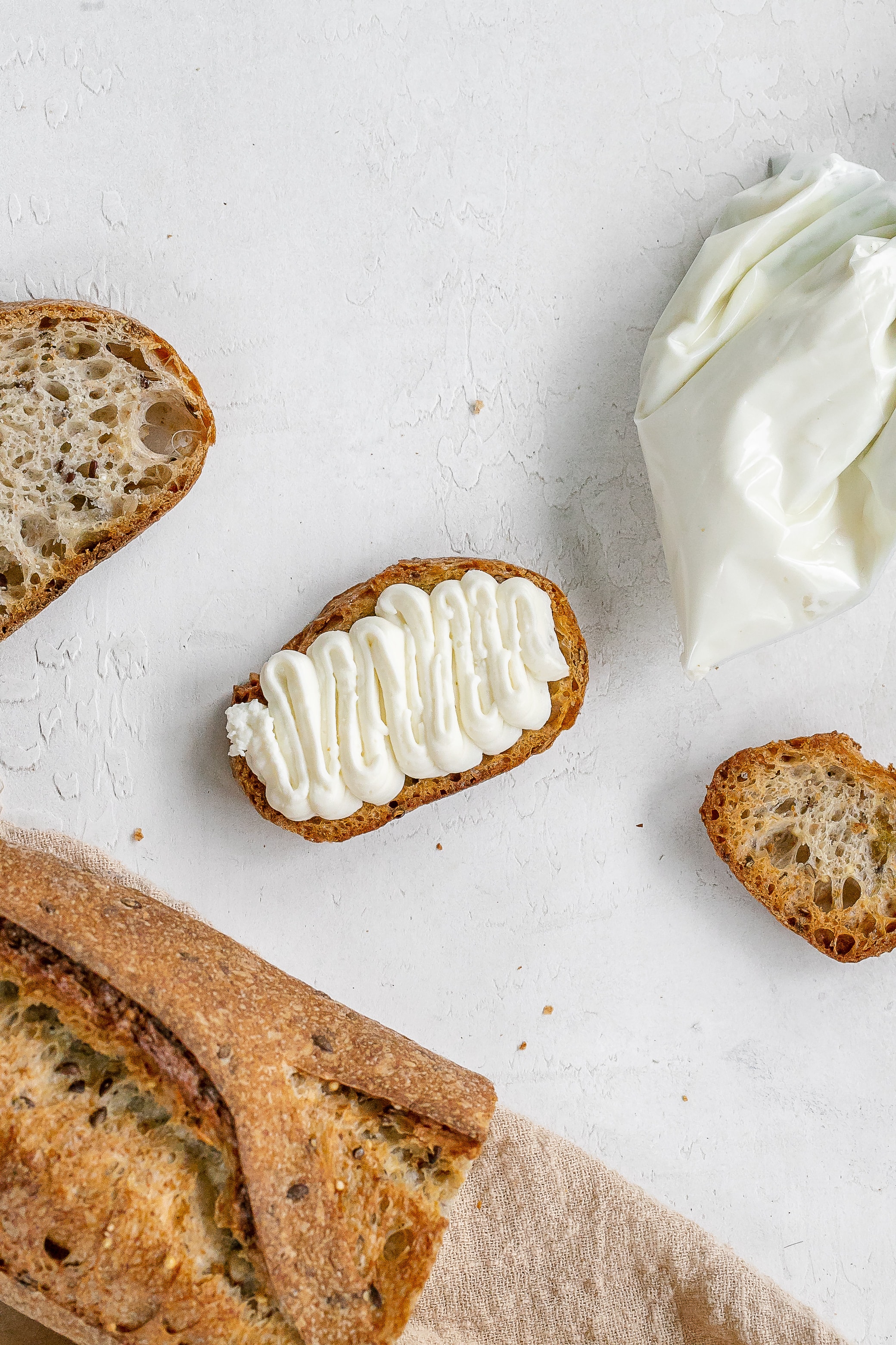 whipped ricotta on crostini with piping bag.