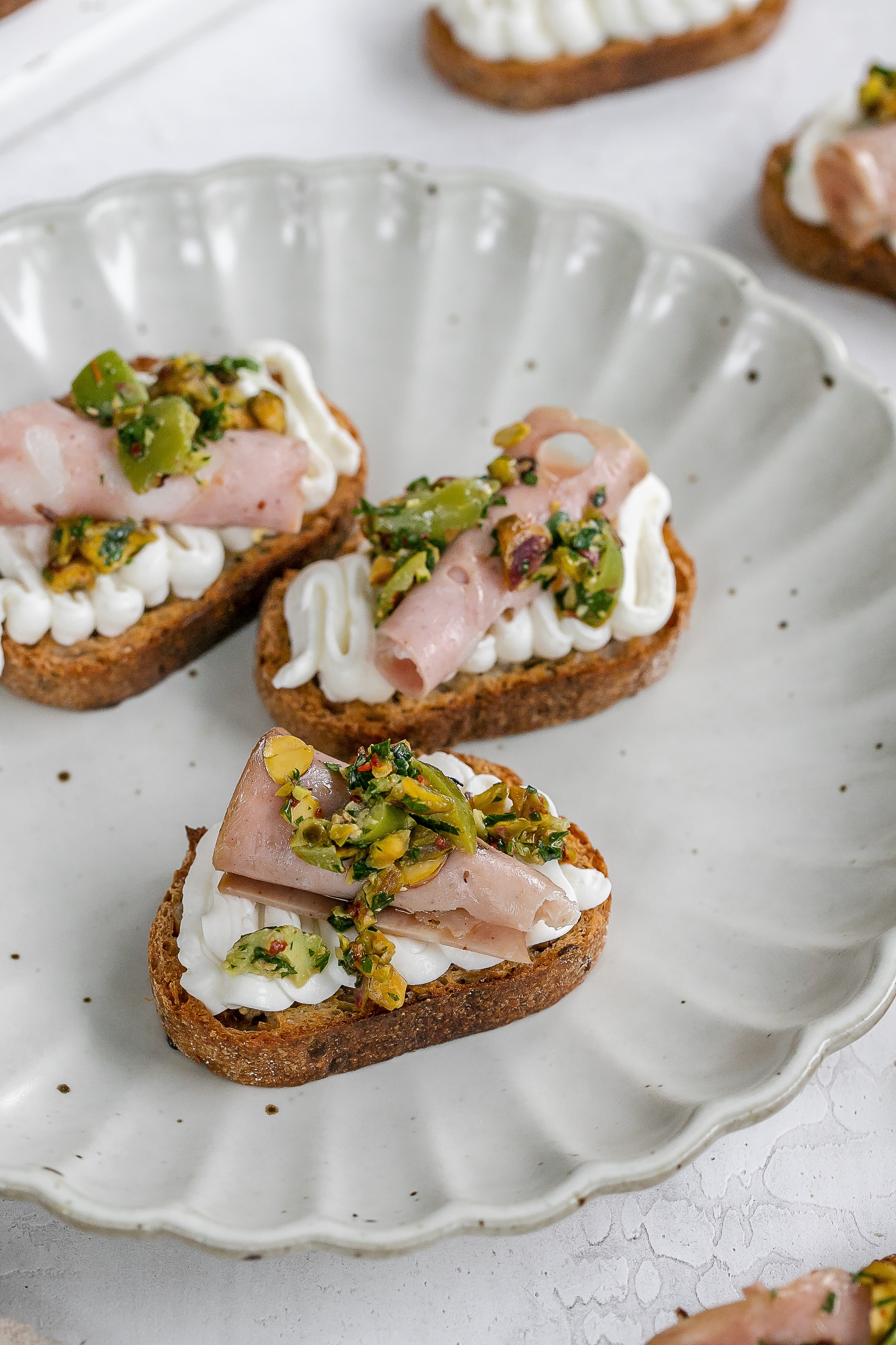 whipped ricotta on a crostini on a plate.