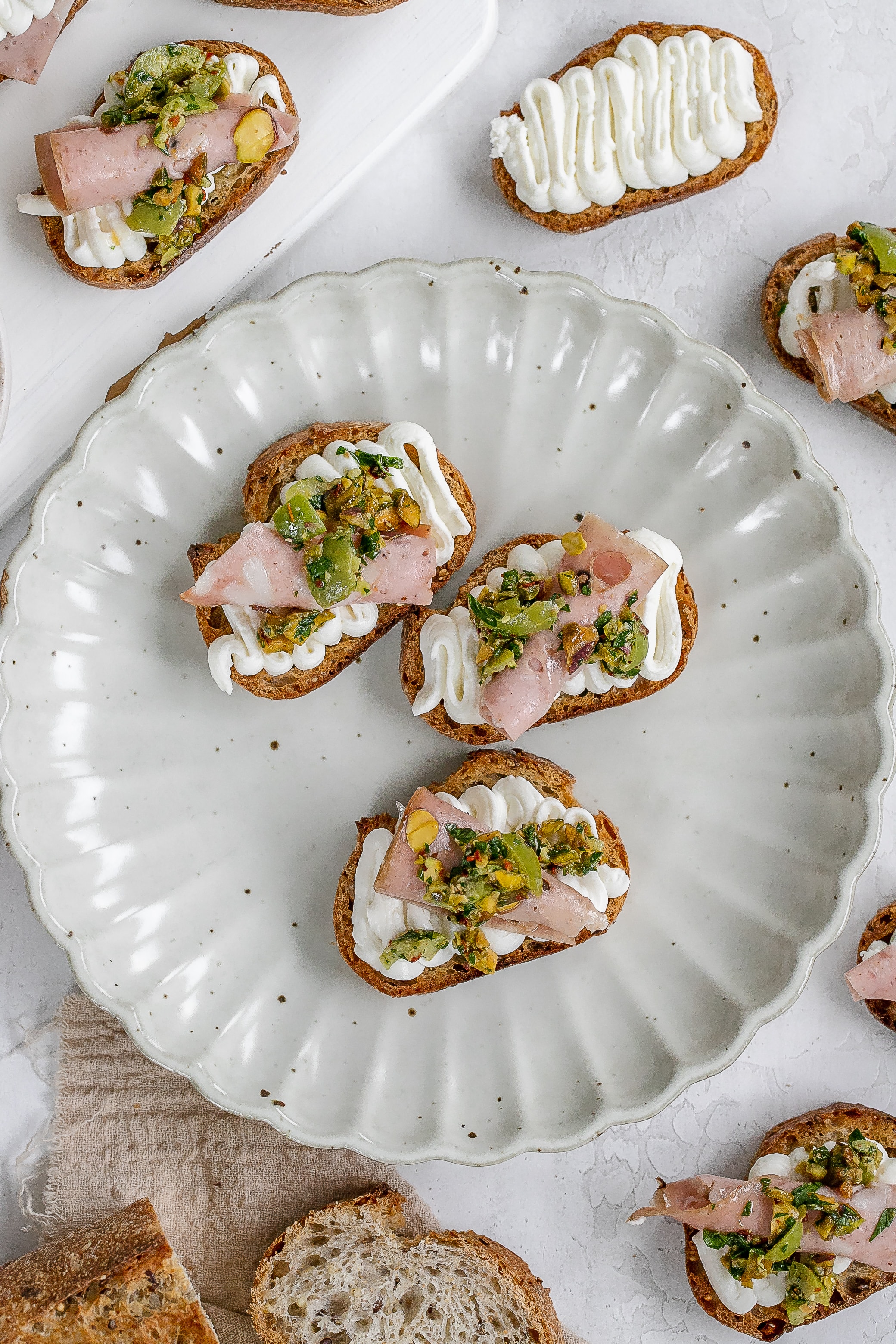 whipped ricotta on a crostini on a plate.