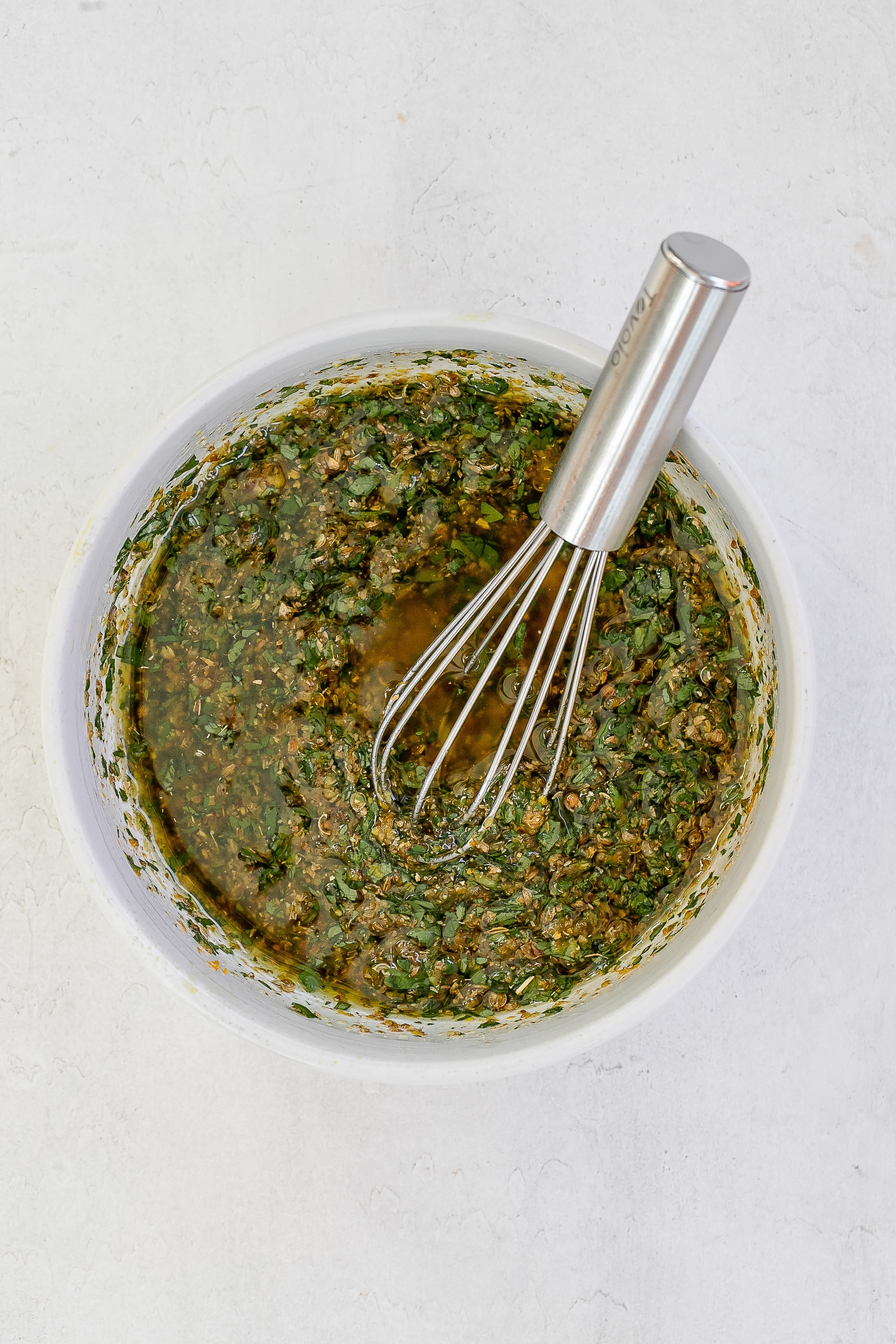 marinade mixture in bowl with whisk. 