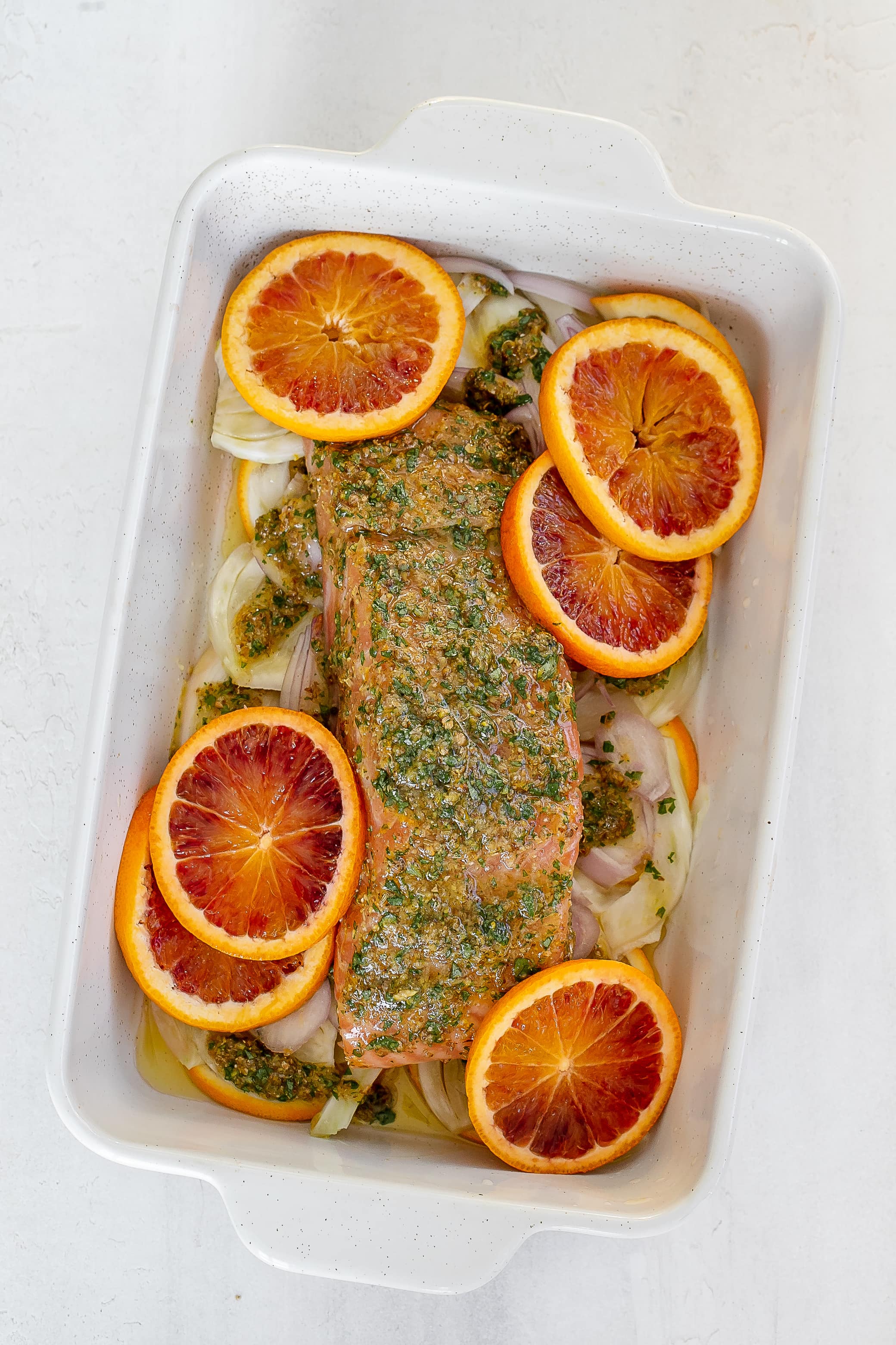 salmon on top of fennel with blood orange slices. 