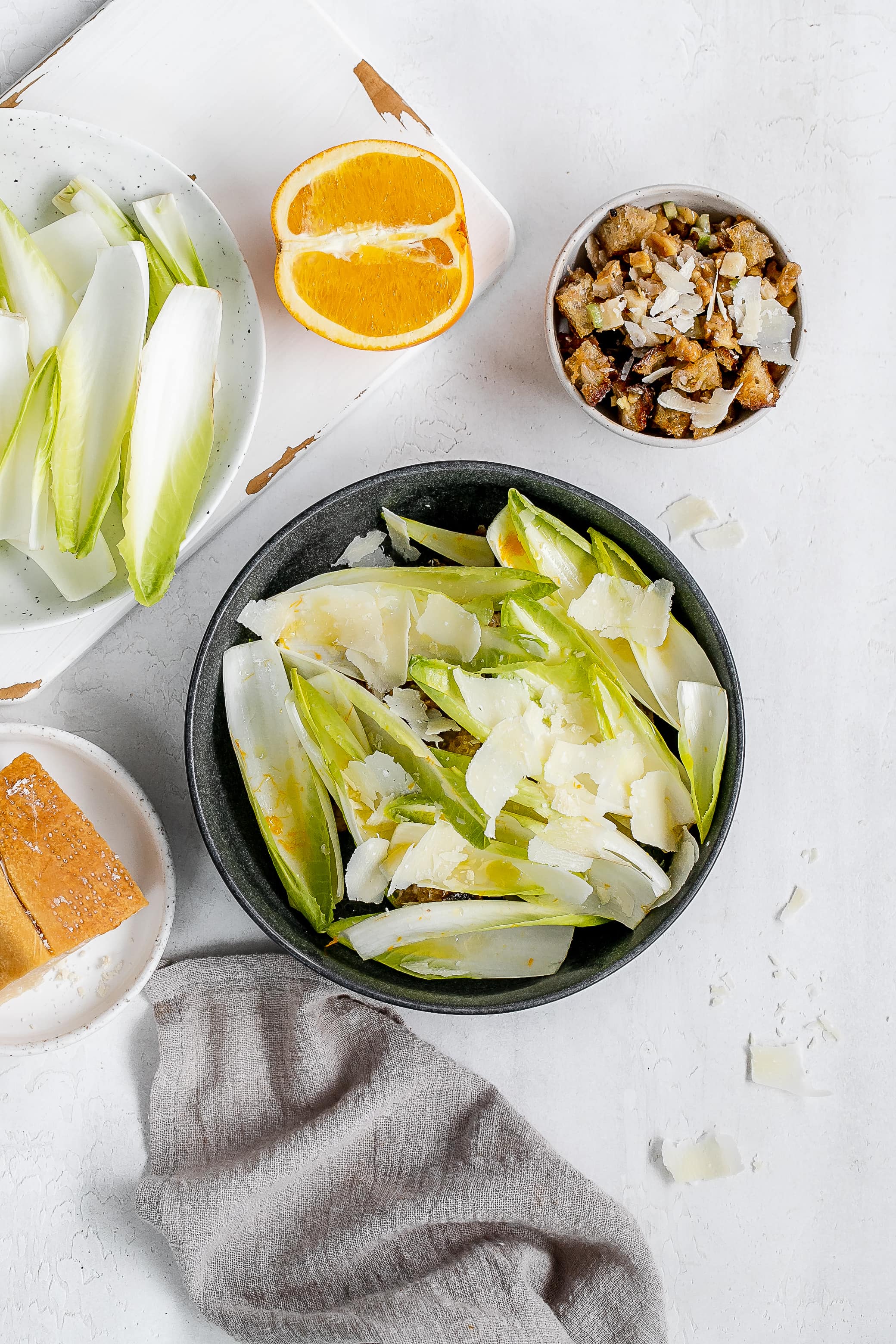 endive boats with filling underneath in bowl.