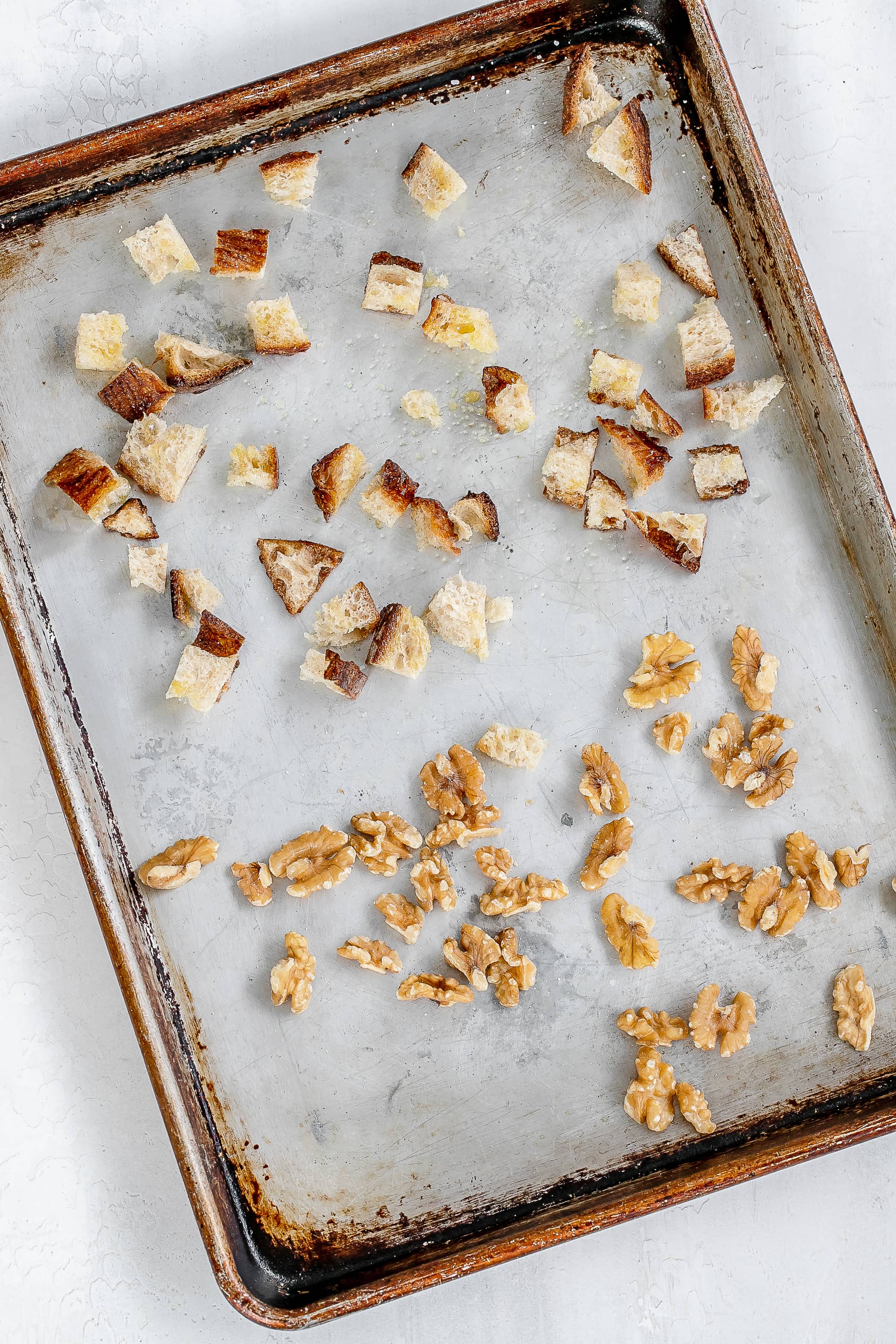 bread and walnuts on baking sheet.