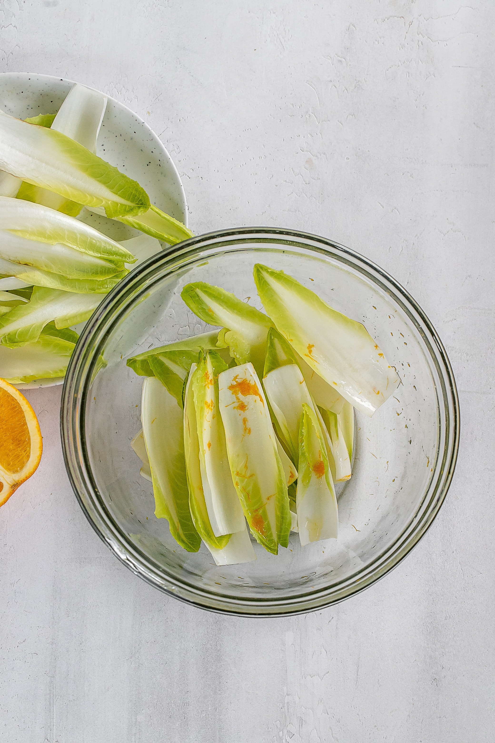 endive cups in bowl with orange zest. 