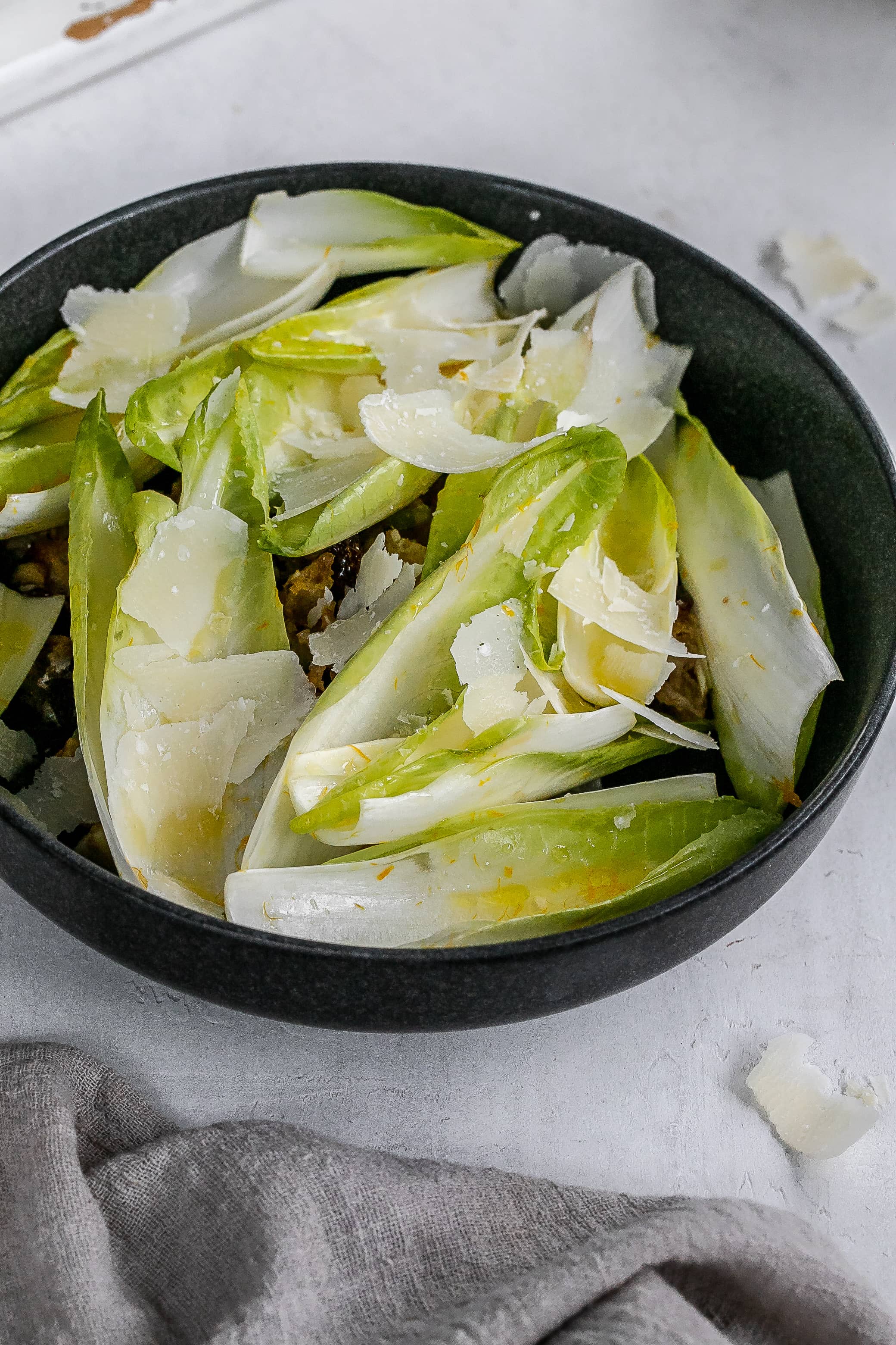 endive boats with filling underneath in bowl.