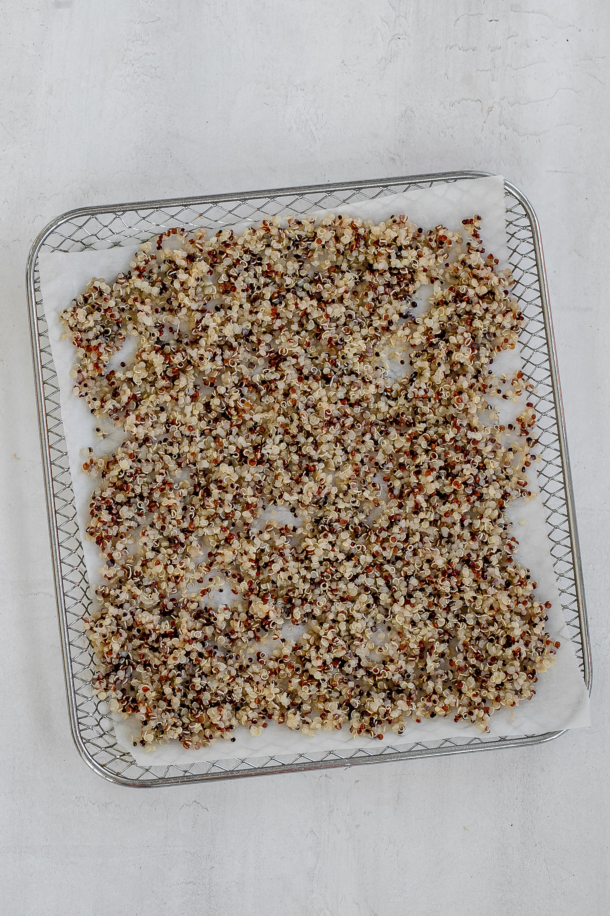 quinoa on air fryer tray.
