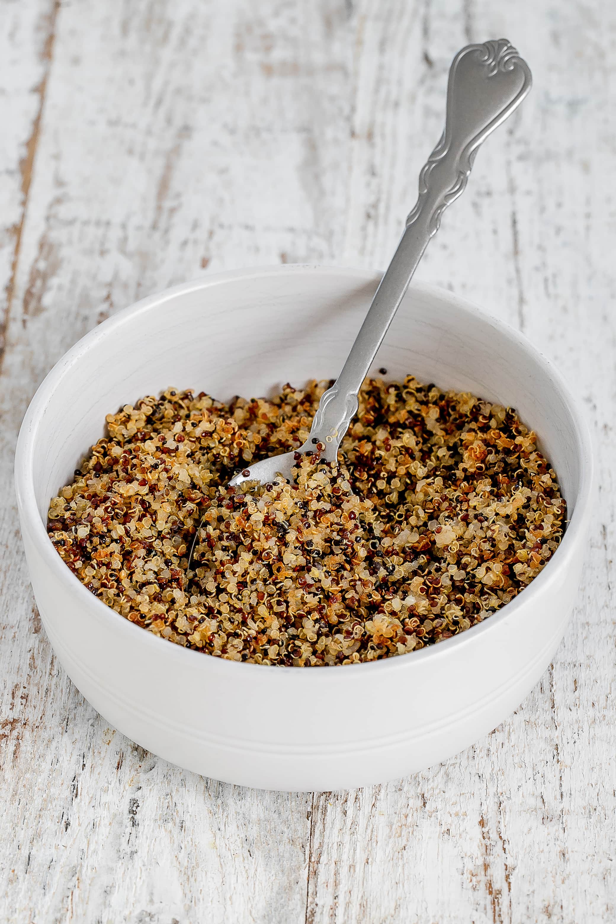 crispy quinoa in bowl with spoon.
