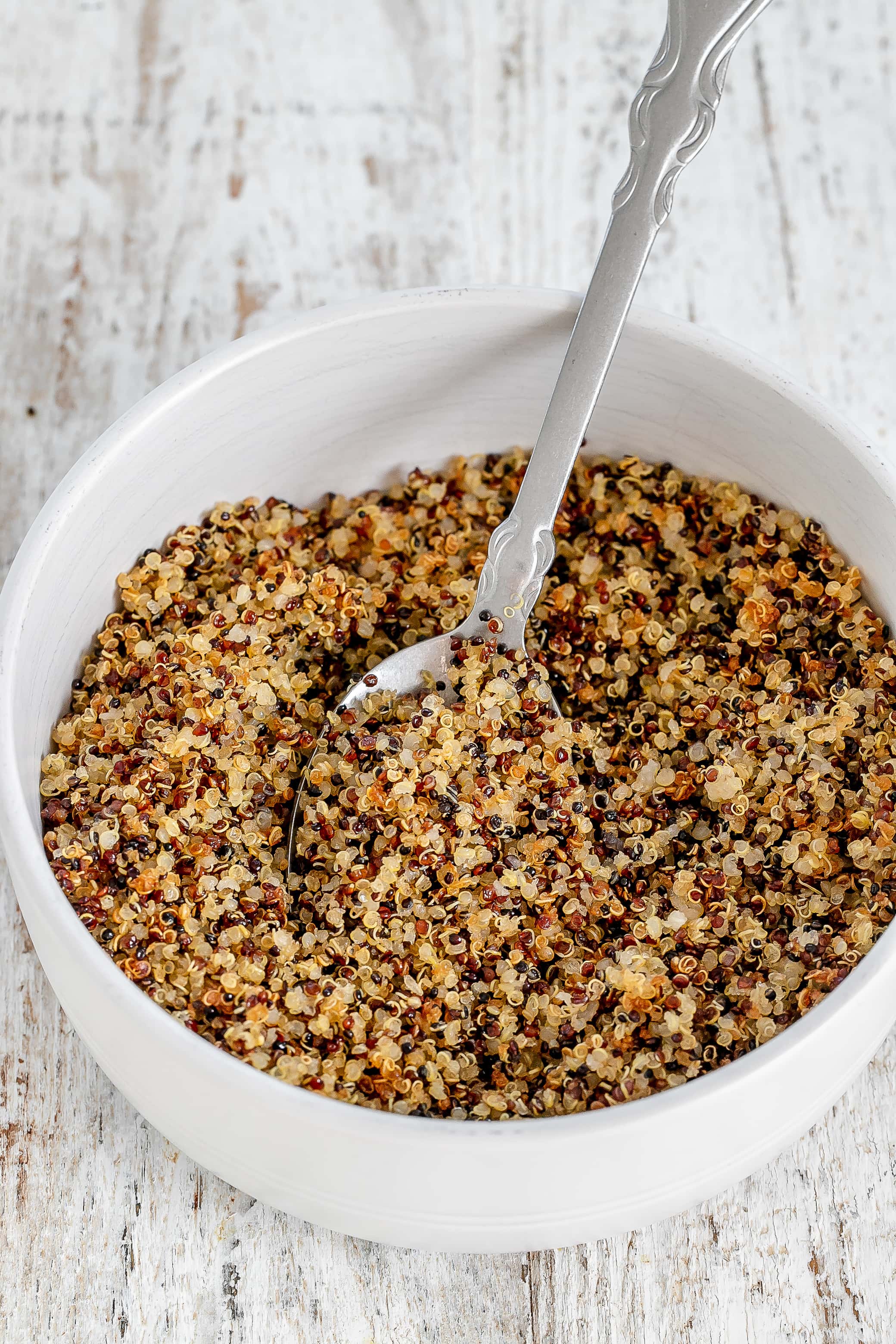 crispy quinoa in bowl with spoon.