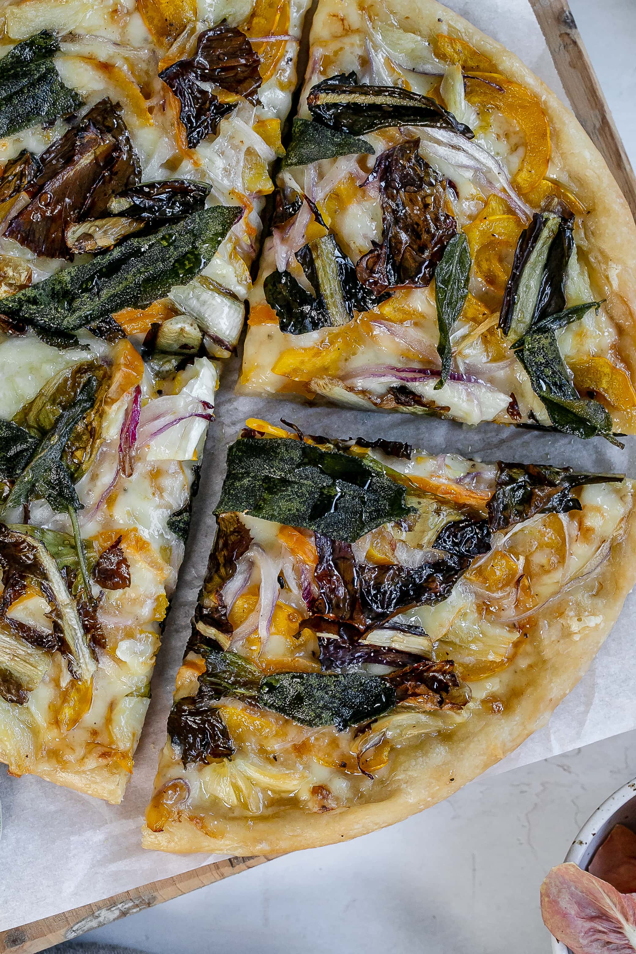 delicata squash pizza on cutting board.