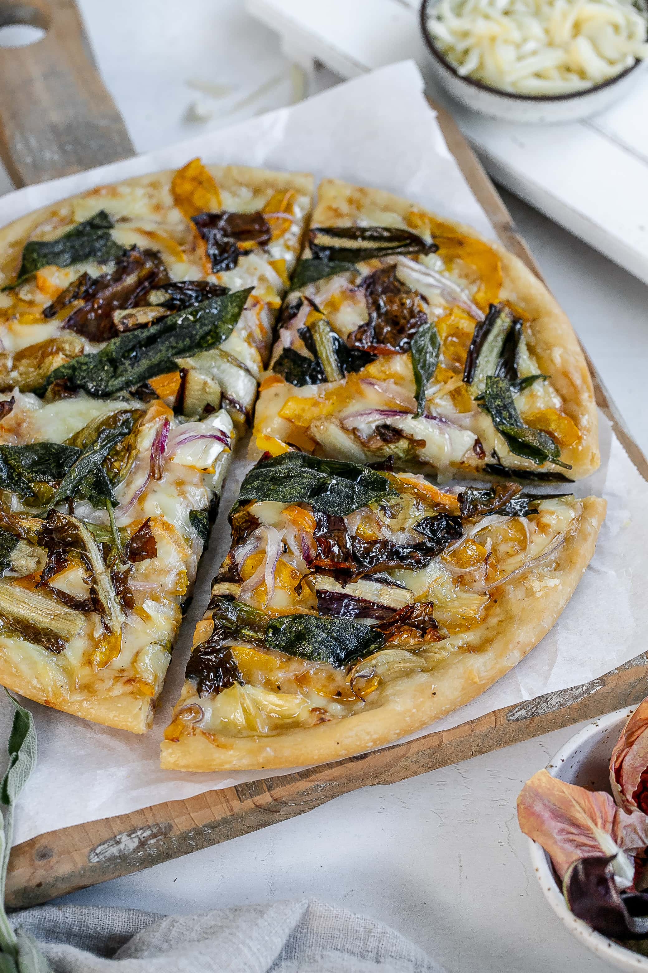 delicata squash pizza on cutting board.