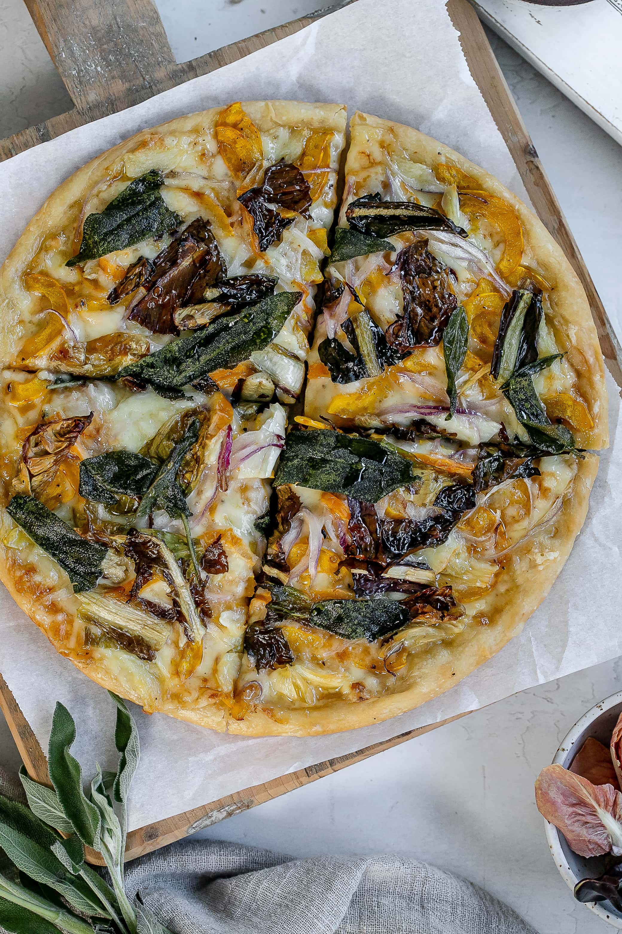 delicata squash pizza on cutting board.
