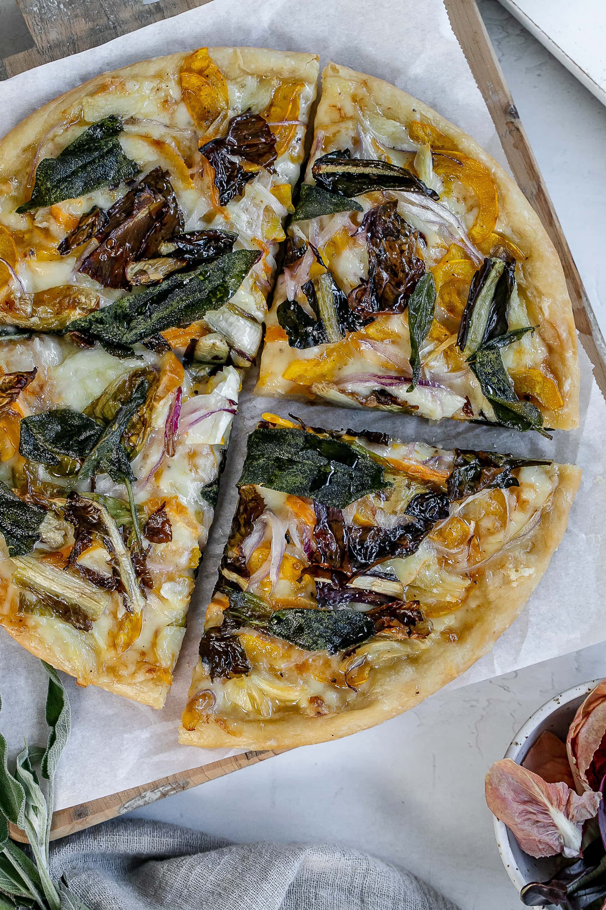 delicata squash pizza on cutting board.