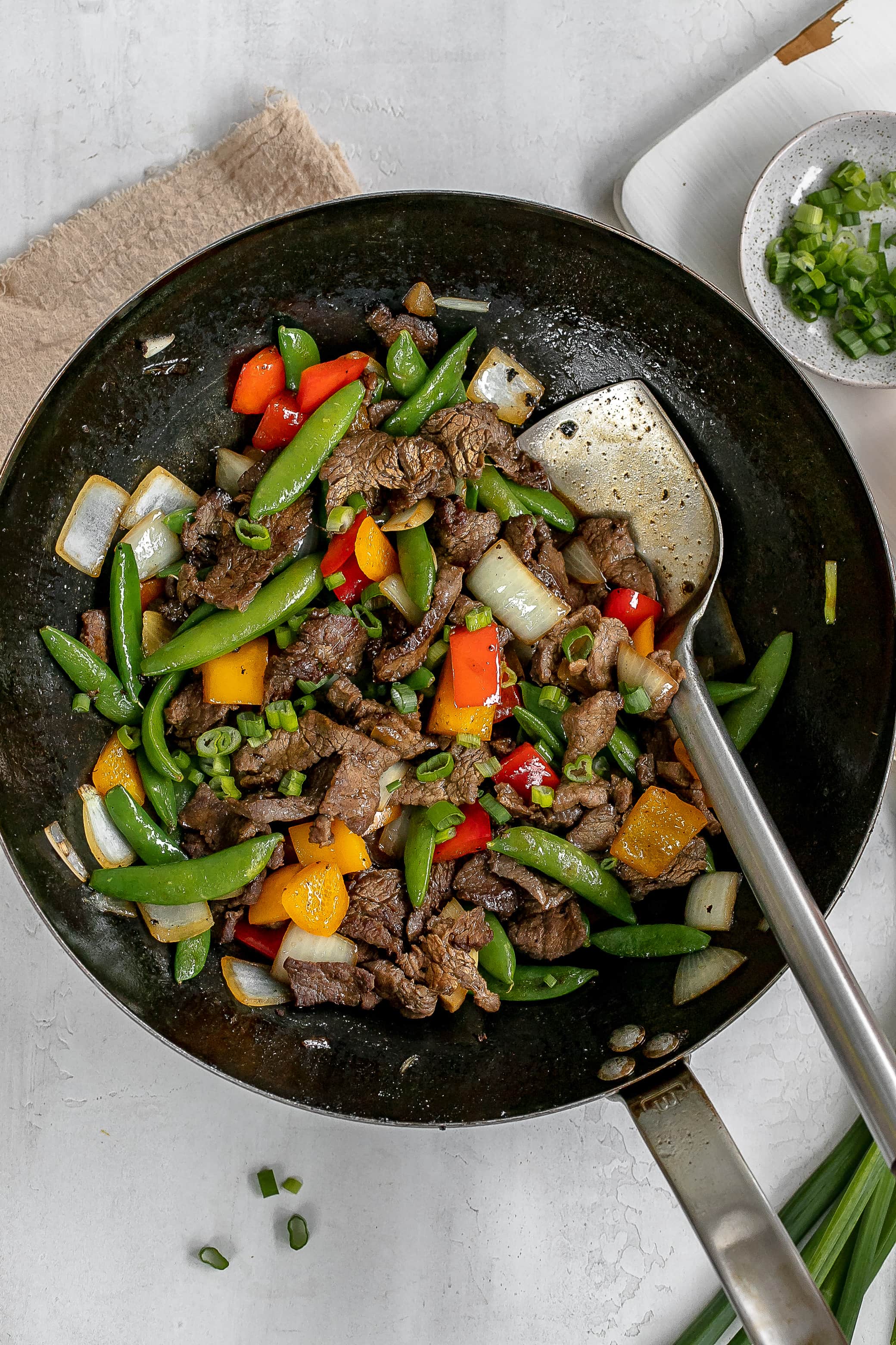 flank steak stir fry in a wok.