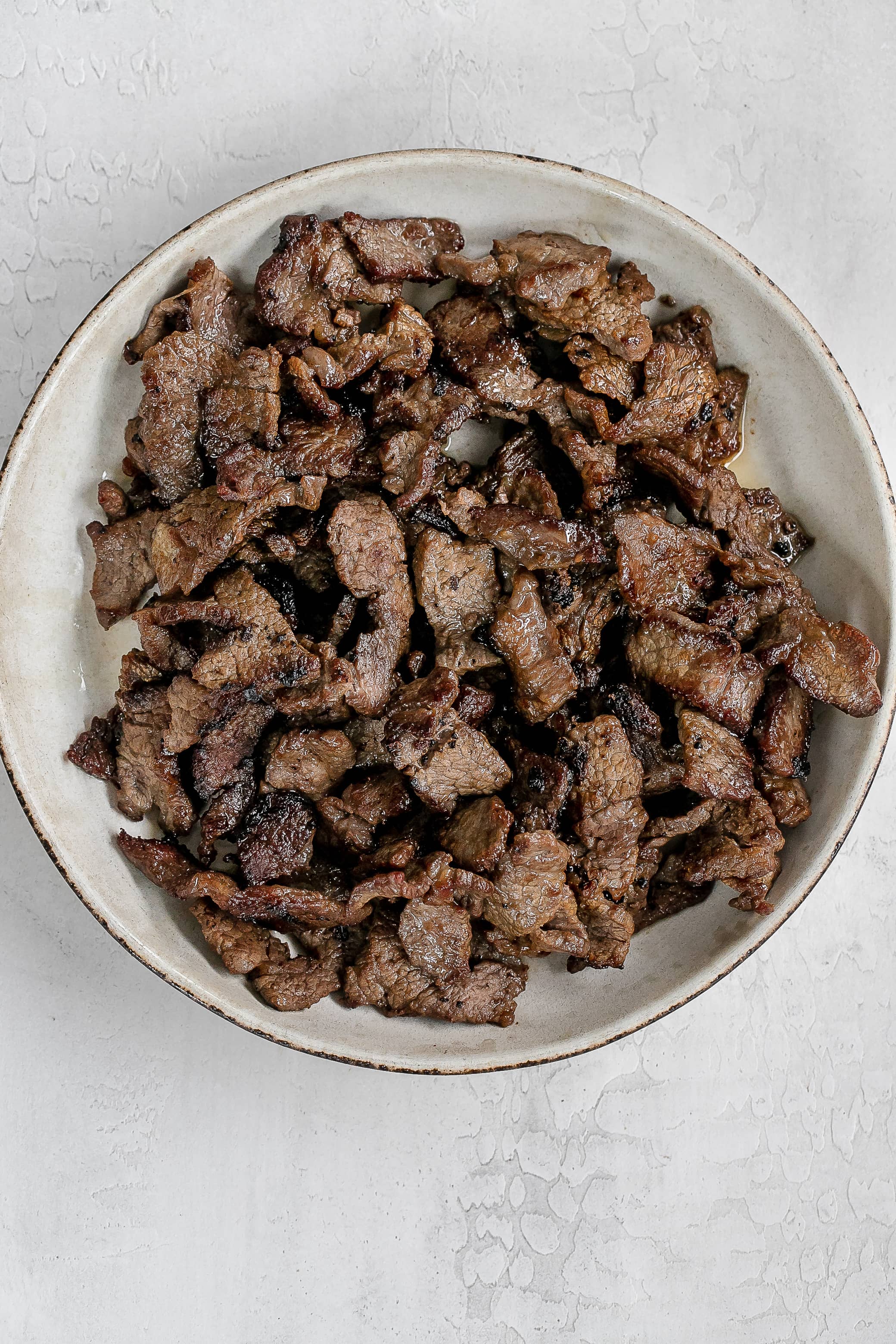 cooked steak slices in bowl. 
