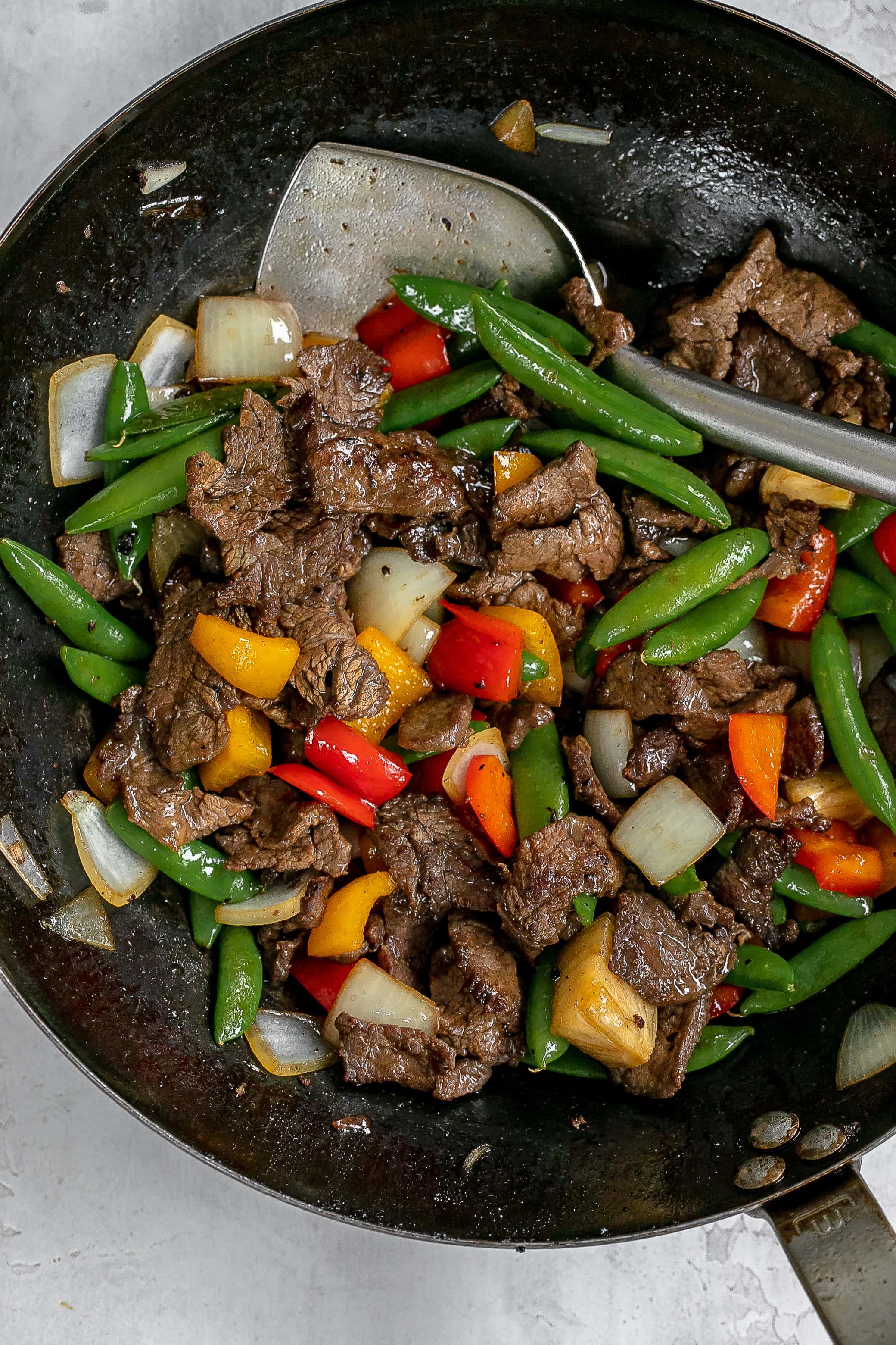 flank steak stir fry in wok.