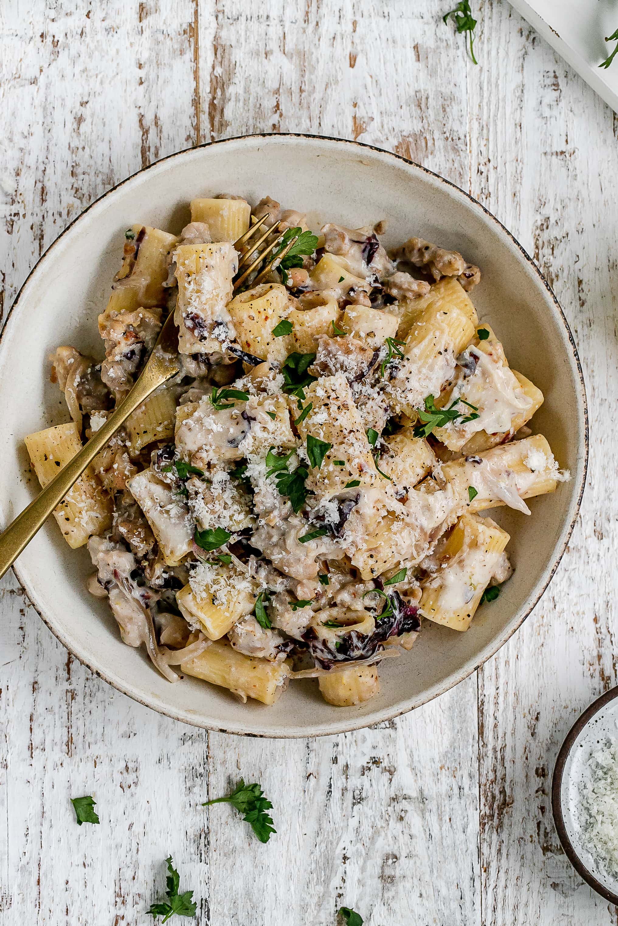 pasta with sausage and ricotta cheese sauce in a bowl.