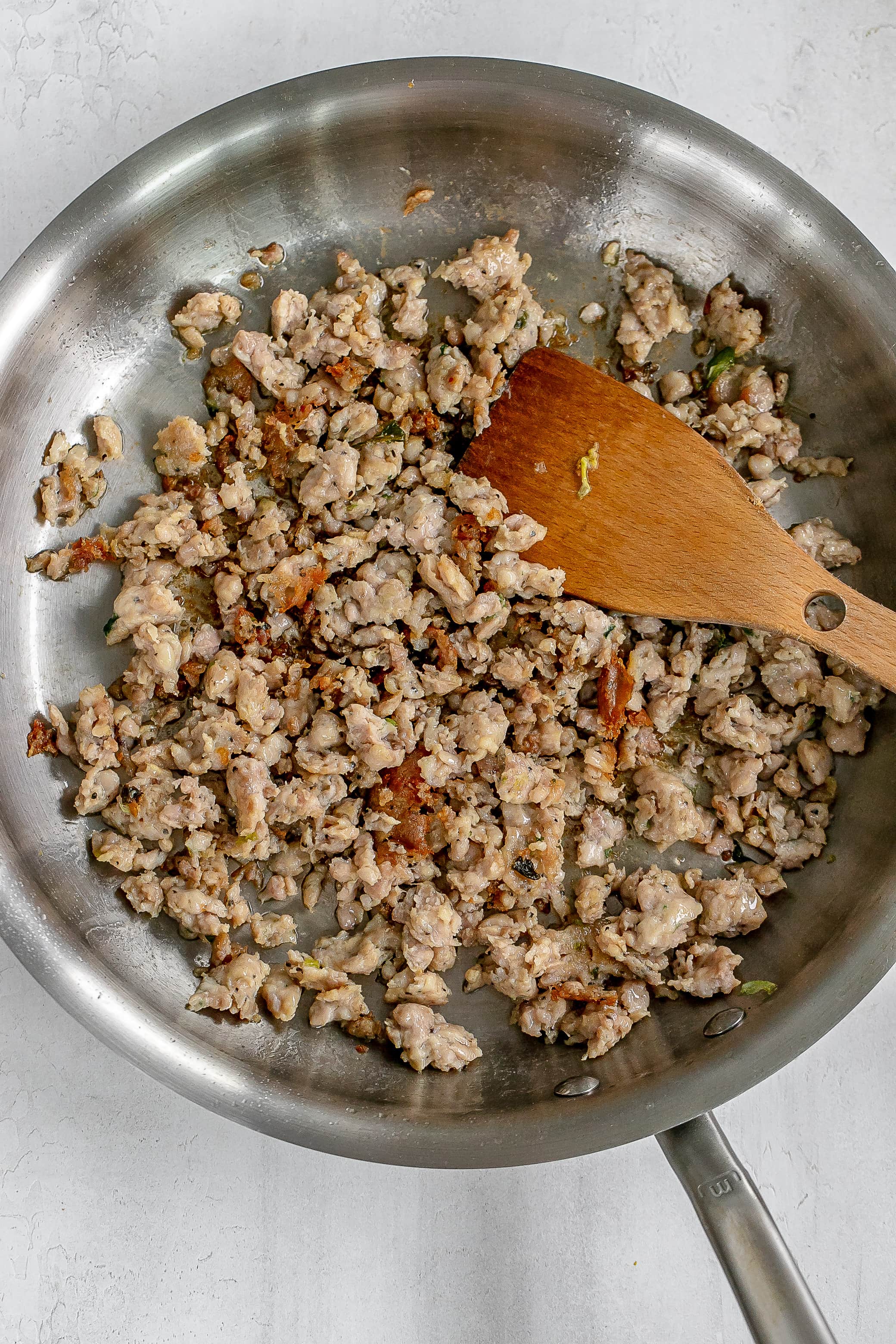 sausage cooking in skillet. 