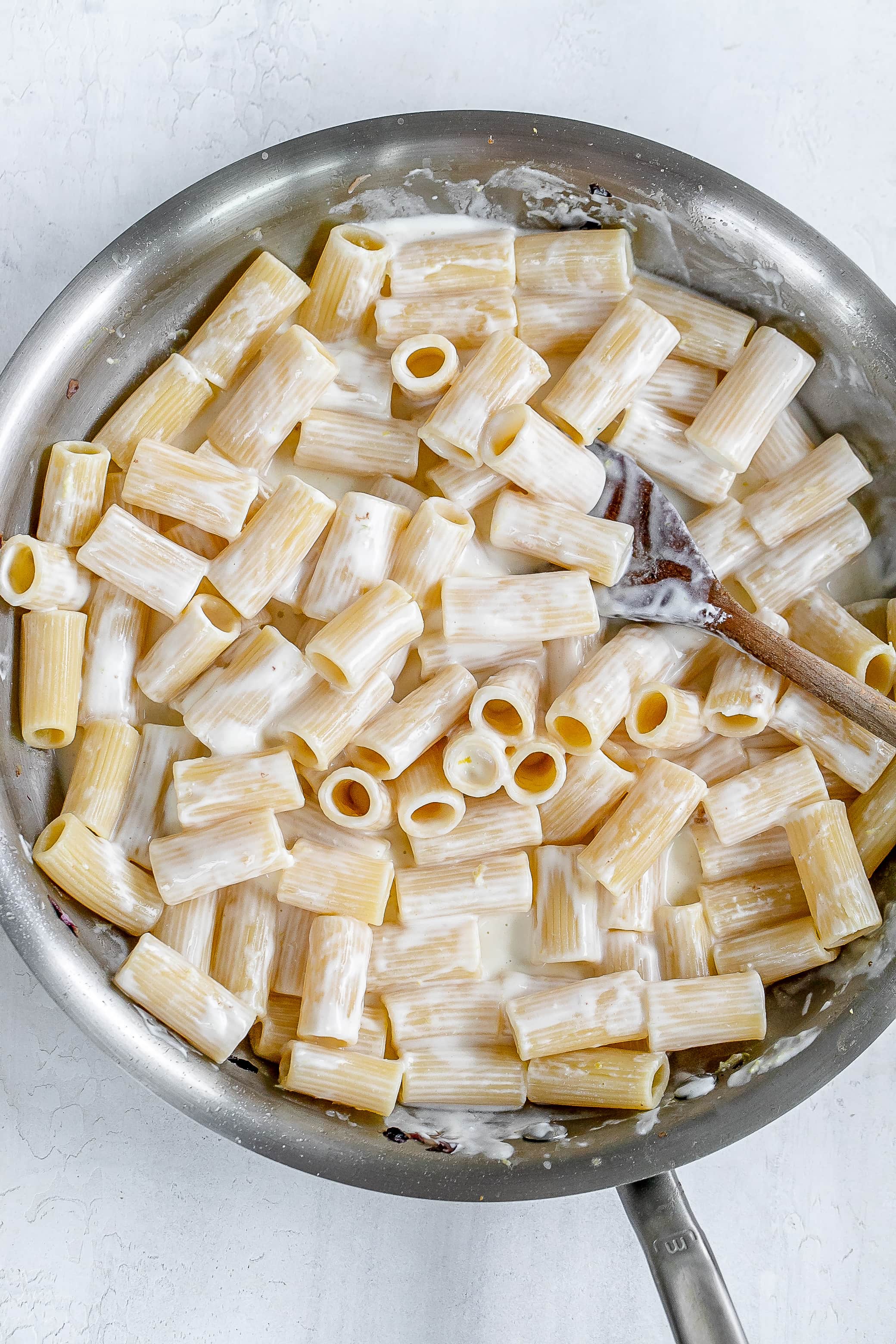 pasta with ricotta sauce in pan.