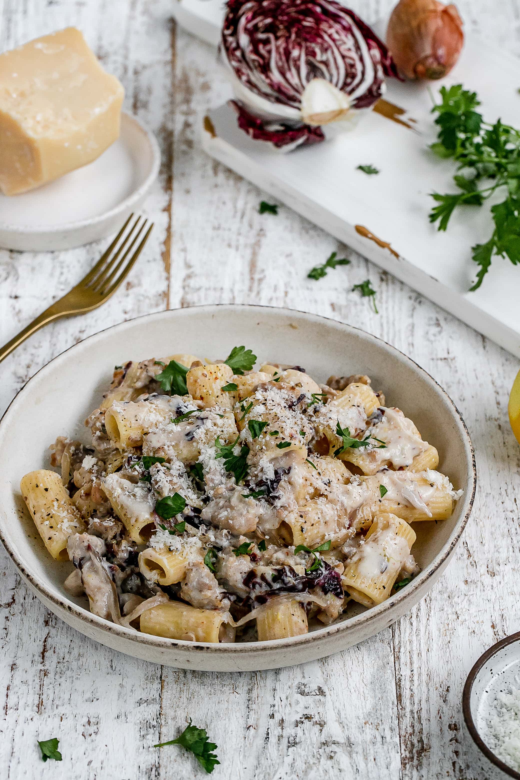 pasta with sausage and ricotta cheese in a pasta bowl.