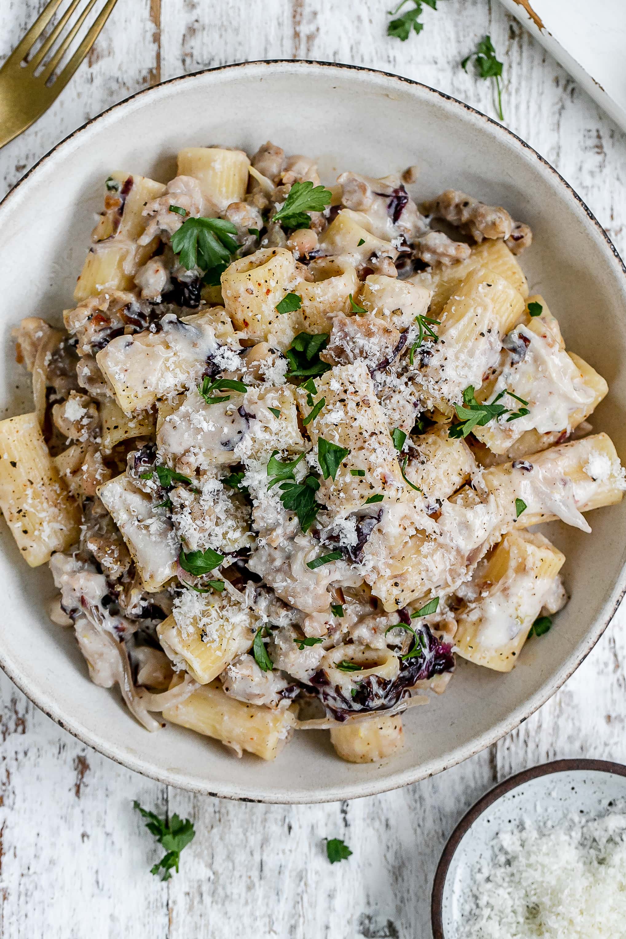 pasta with sausage and ricotta cheese in a pasta bowl.