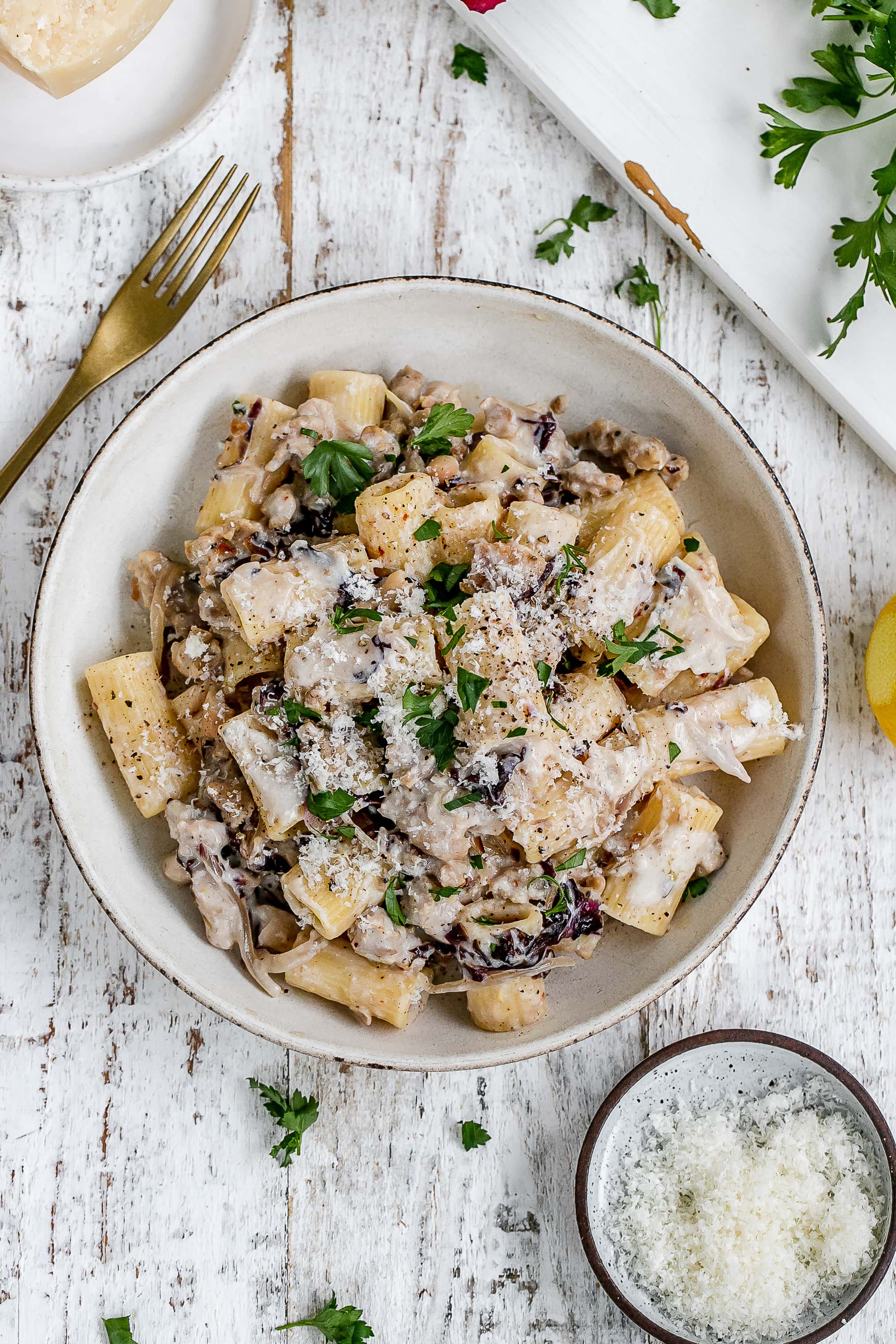 pasta with sausage and ricotta cheese in a pasta bowl.