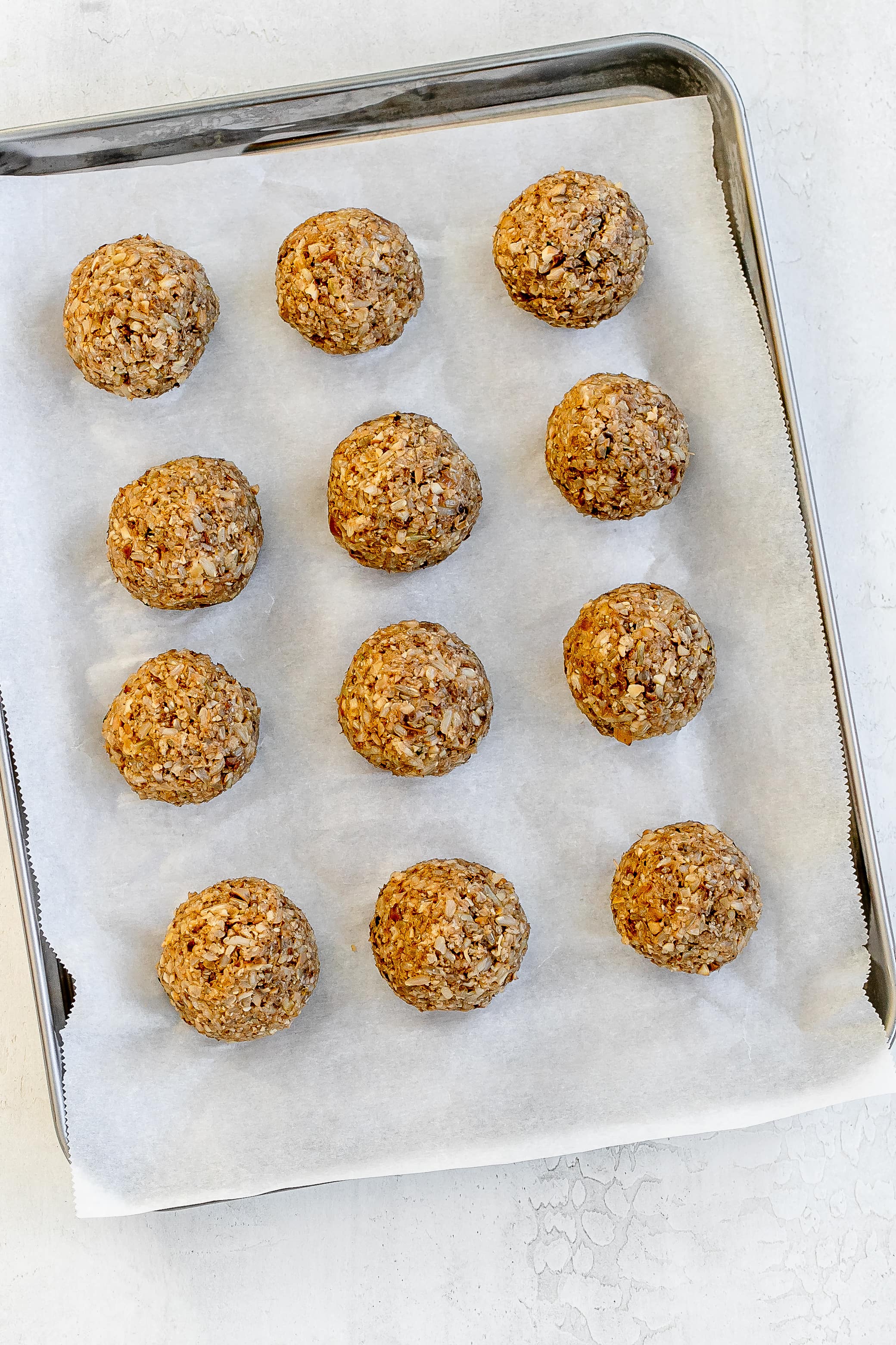 vegan mushroom balls on baking sheet before cooking.
