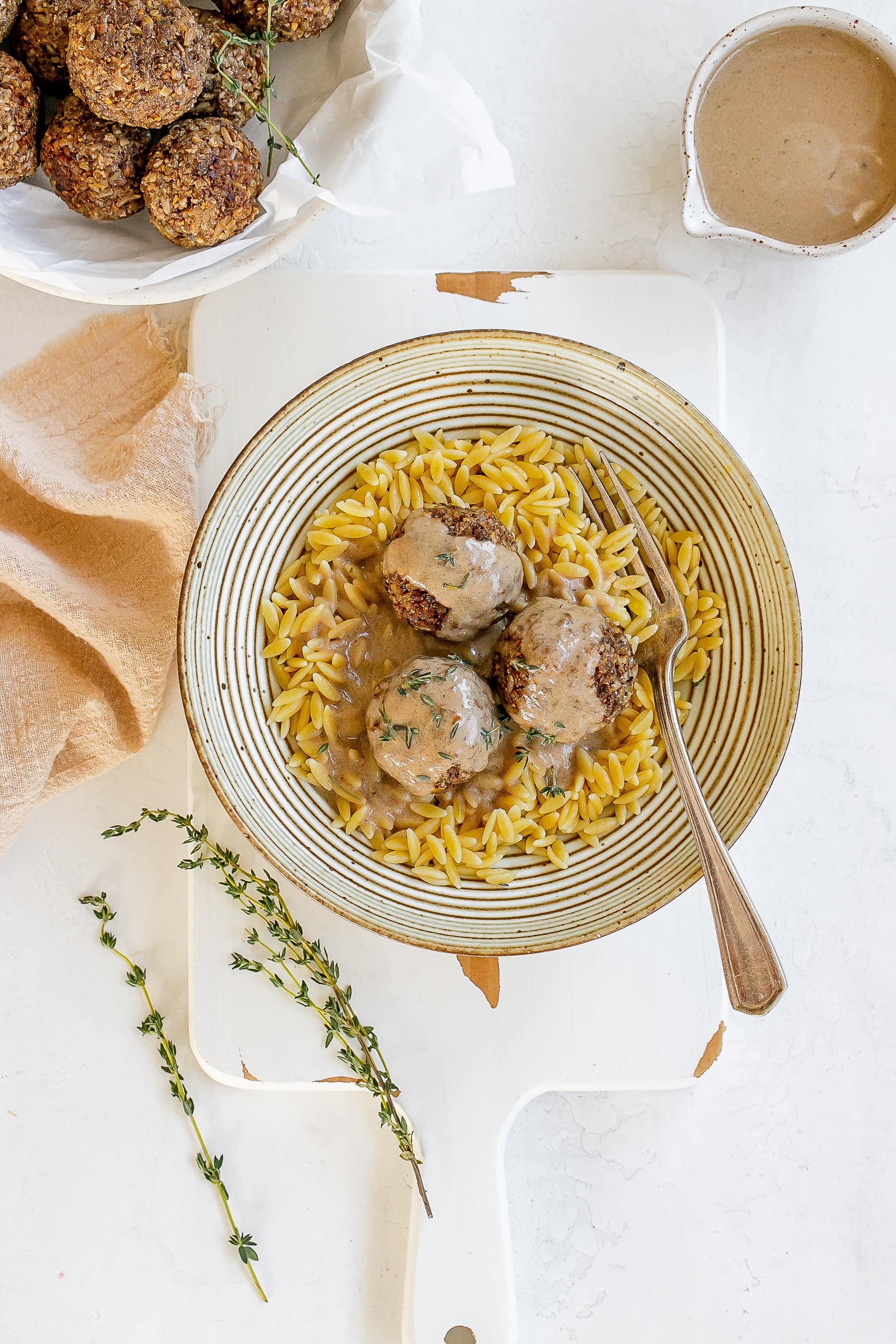 mushroom meatballs in a bowl with orzo and sauce.