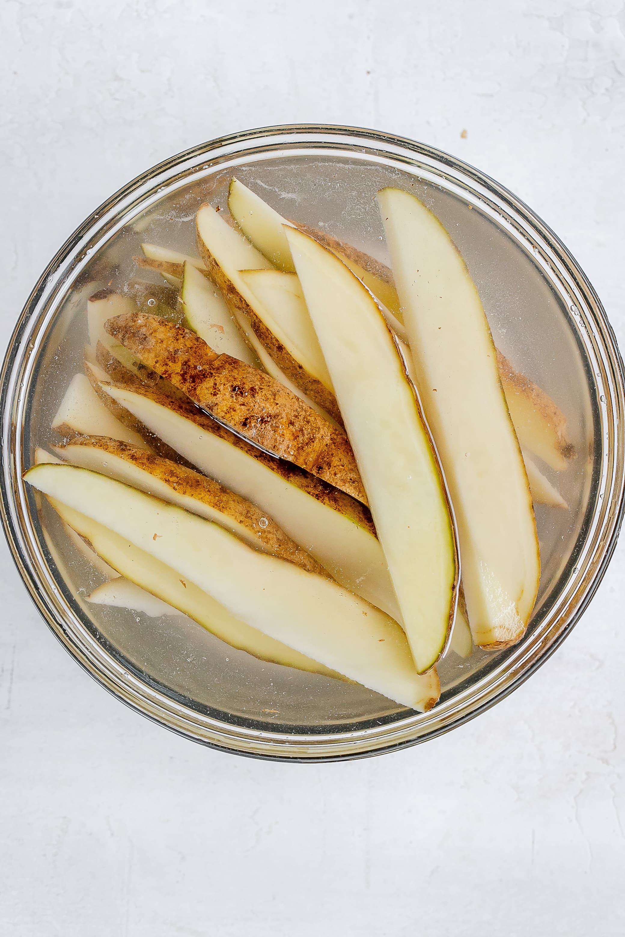 potato wedges in bowl with water.