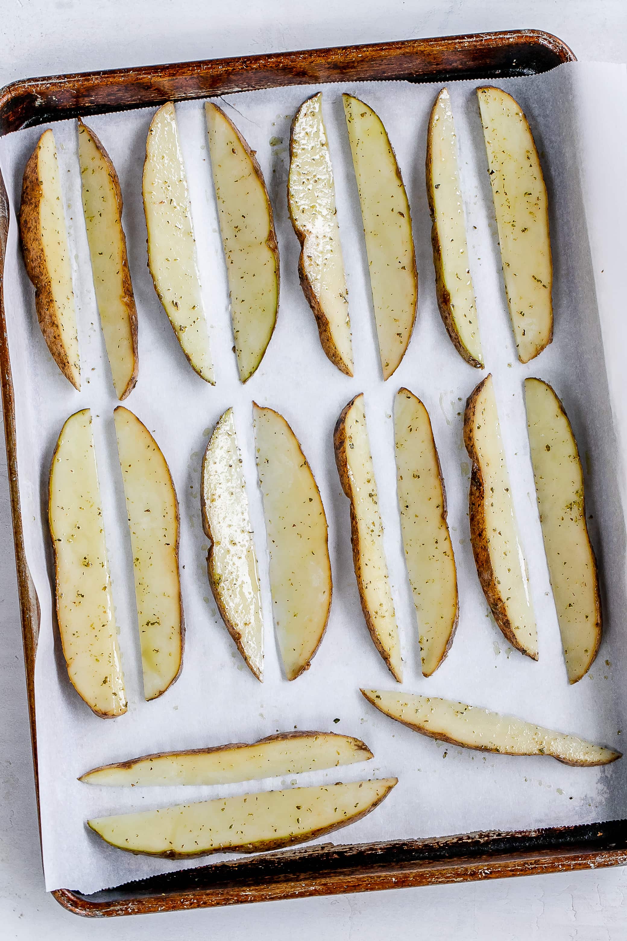 potato wedges on baking sheet before baking.