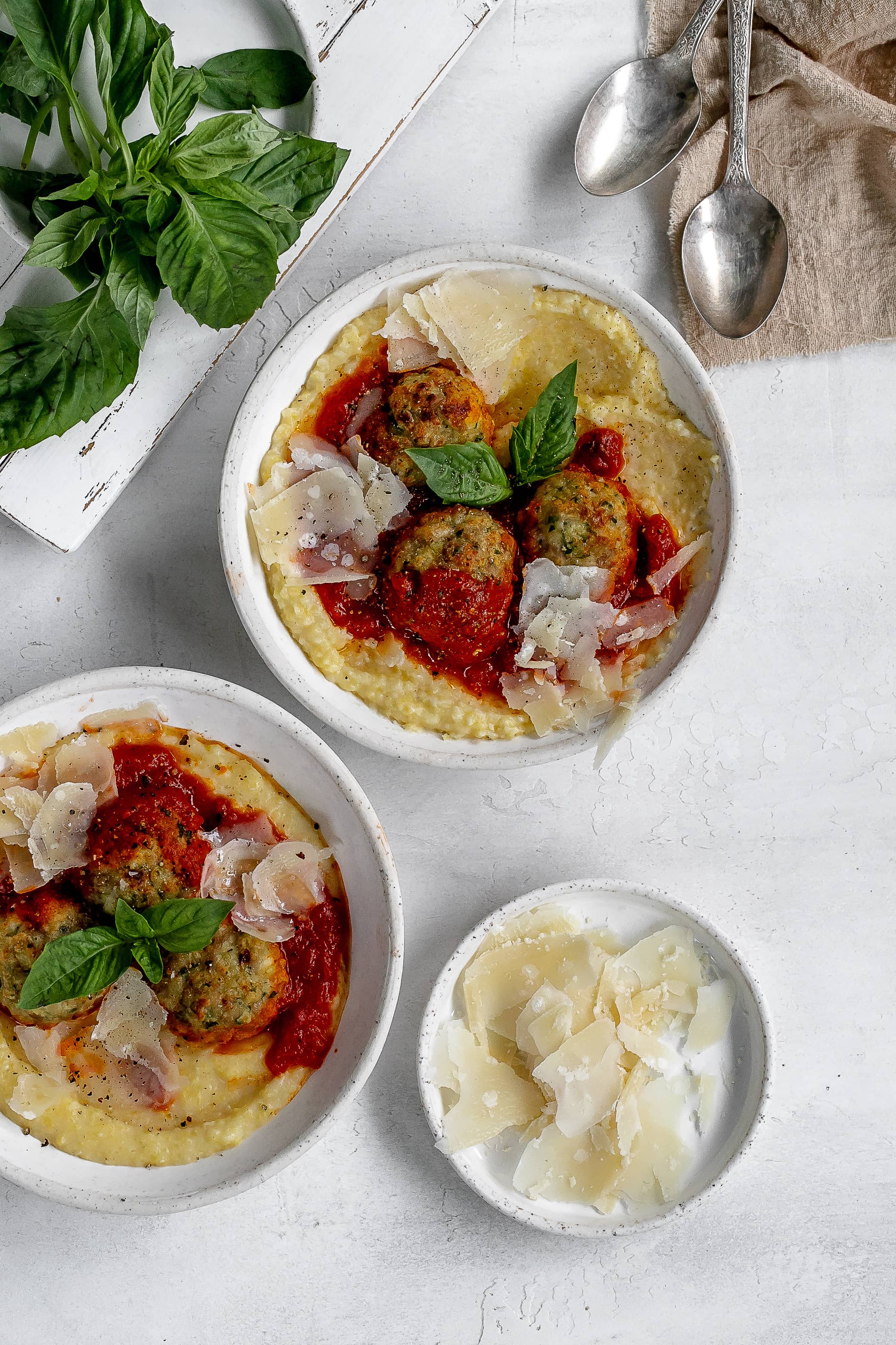 polenta in a bowl with meatballs on top.