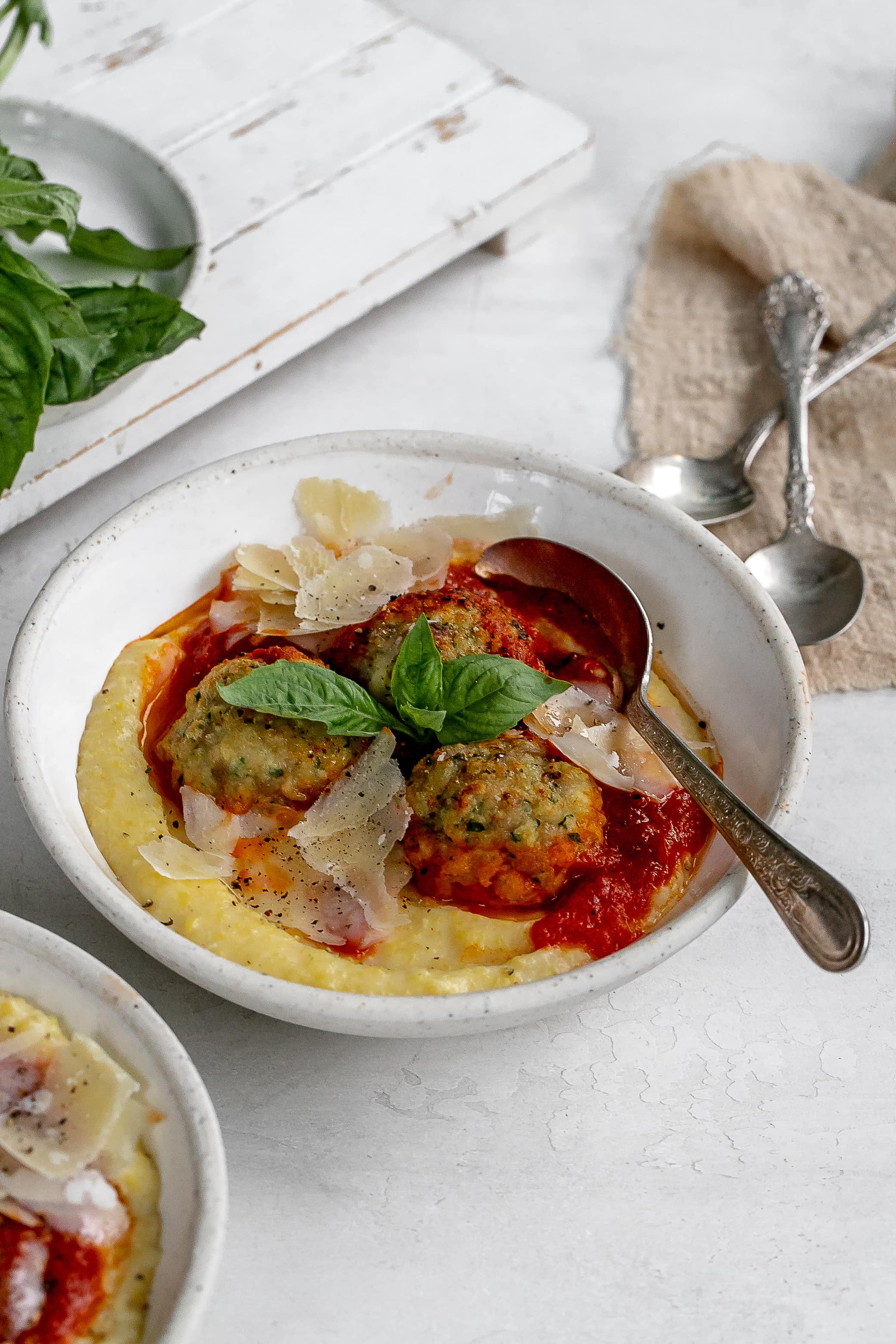 polenta in a bowl with meatballs on top.