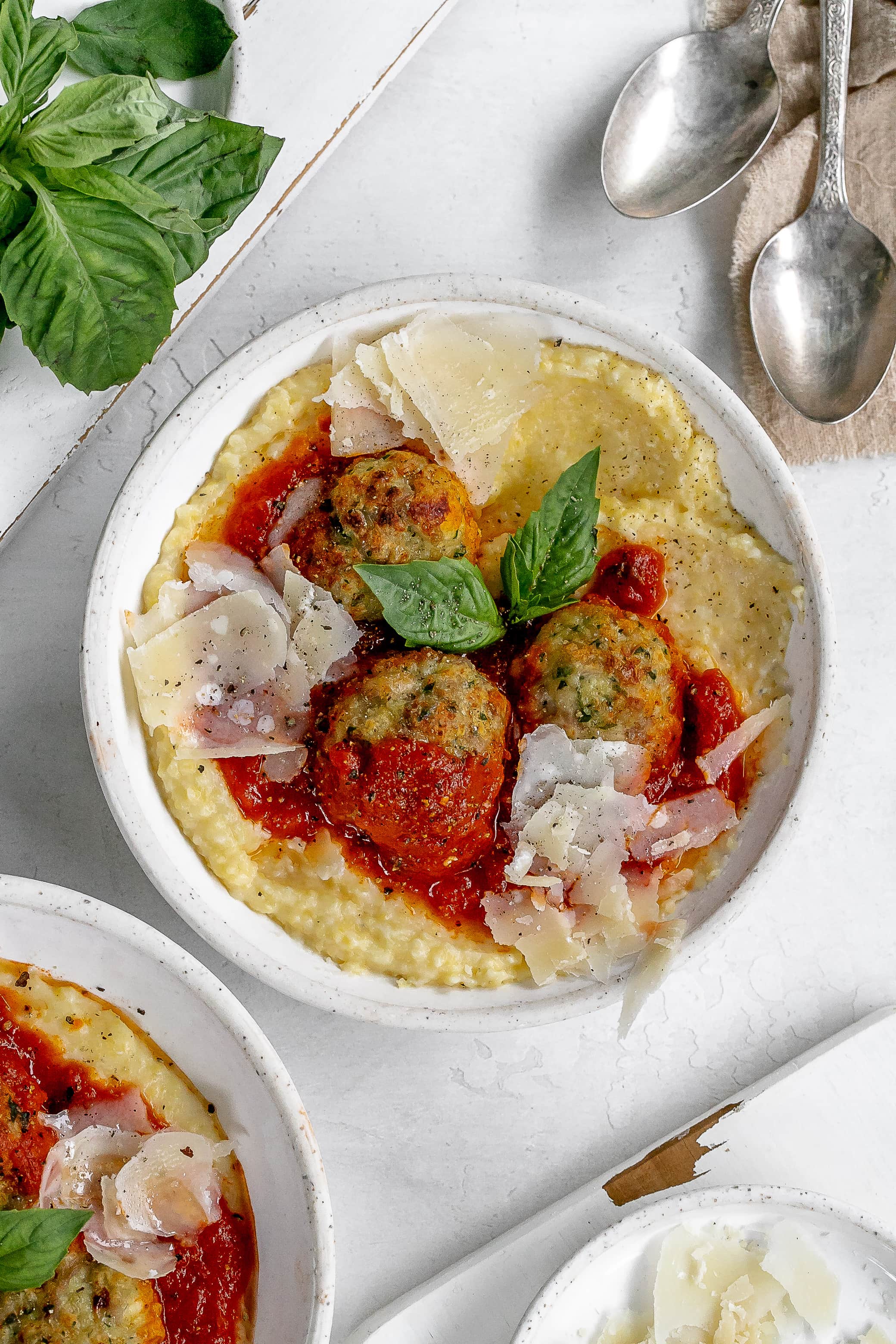 polenta in a bowl with meatballs on top.