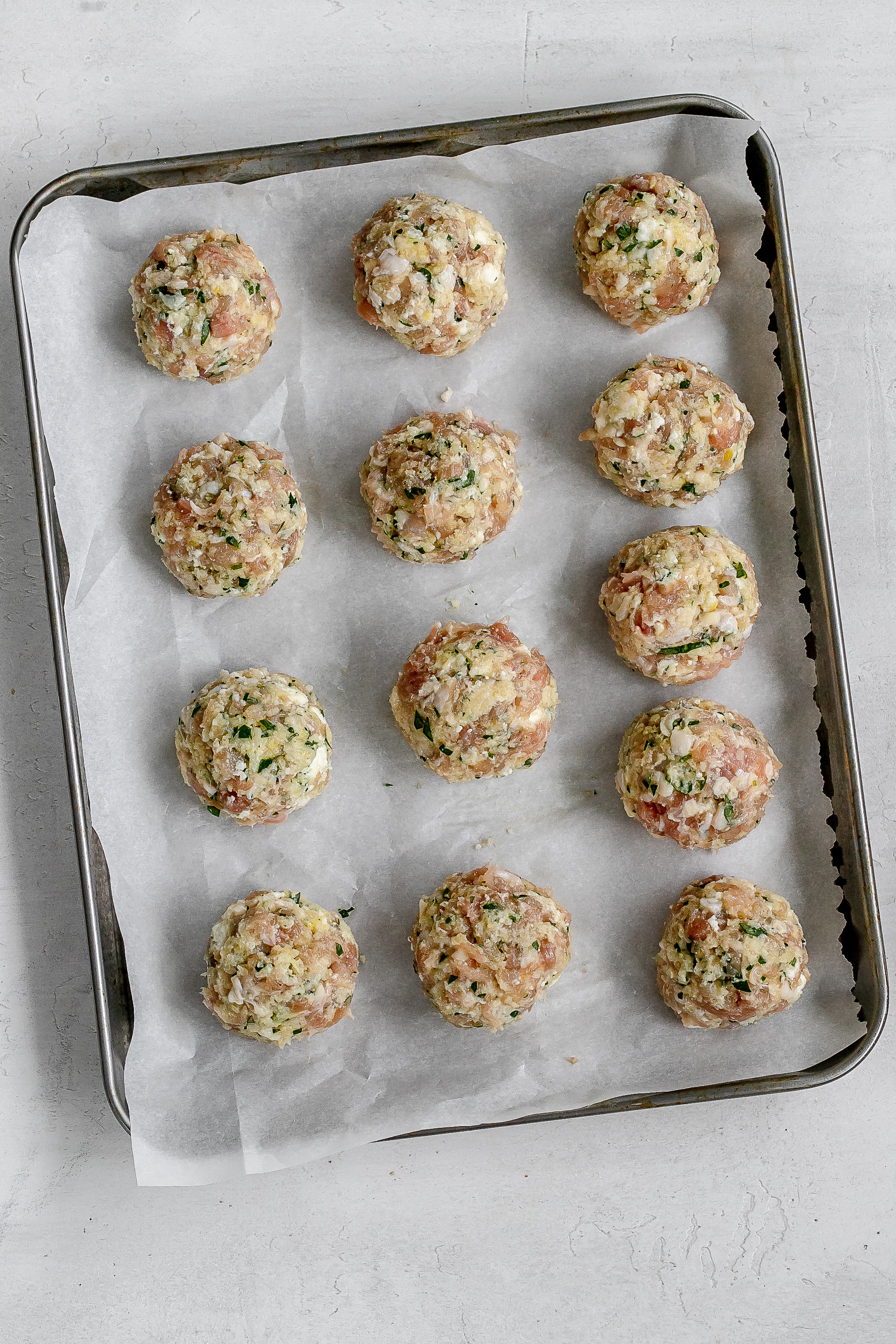 meatballs on baking sheet before cooking.