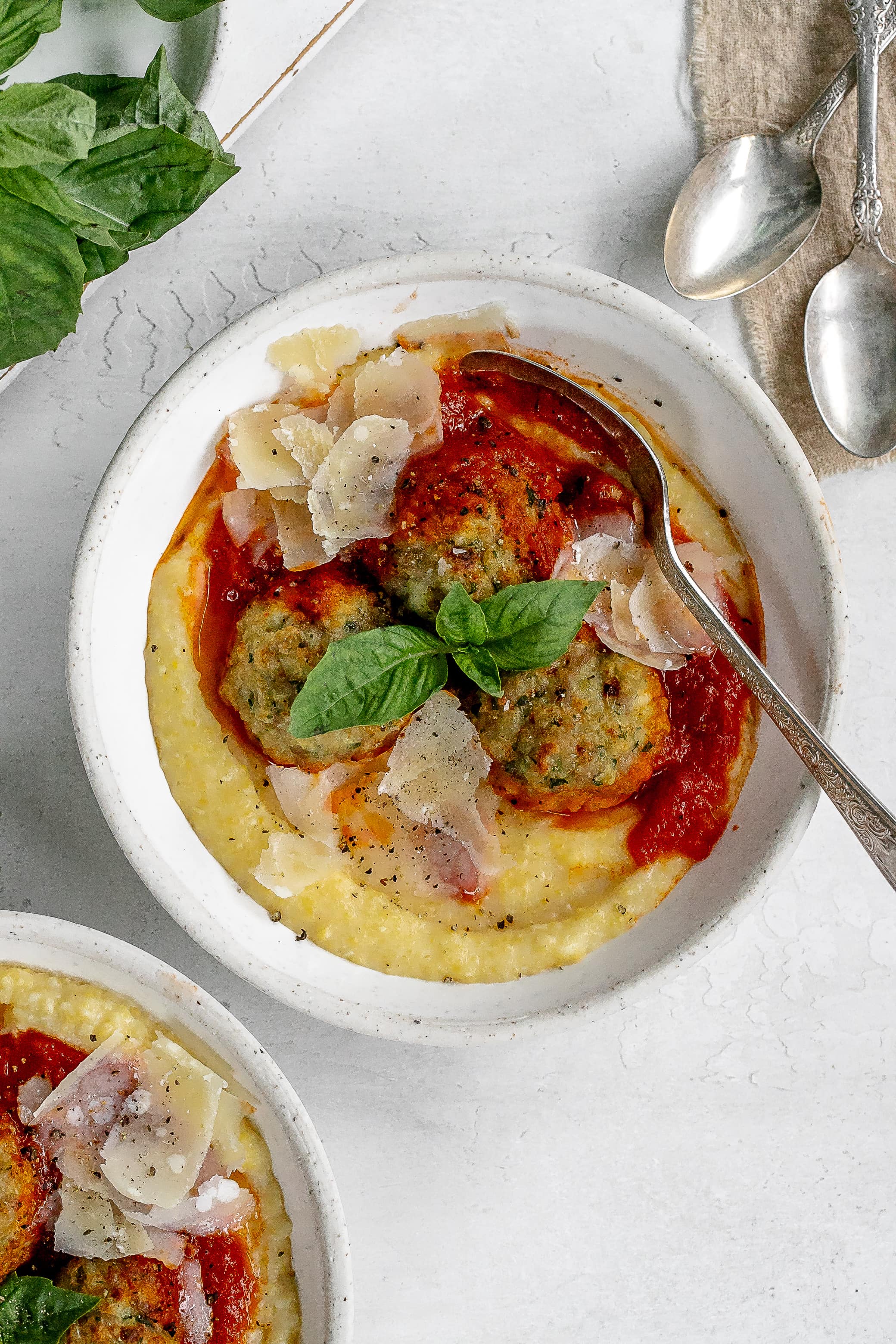 polenta in a bowl with meatballs on top.