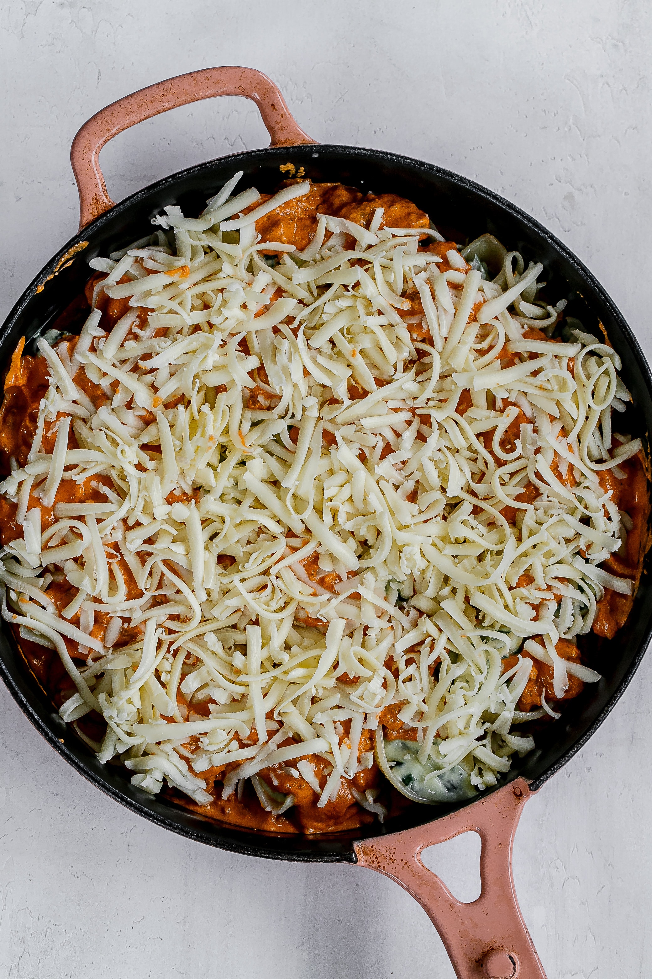 sauce and cheese added on top of shells. 