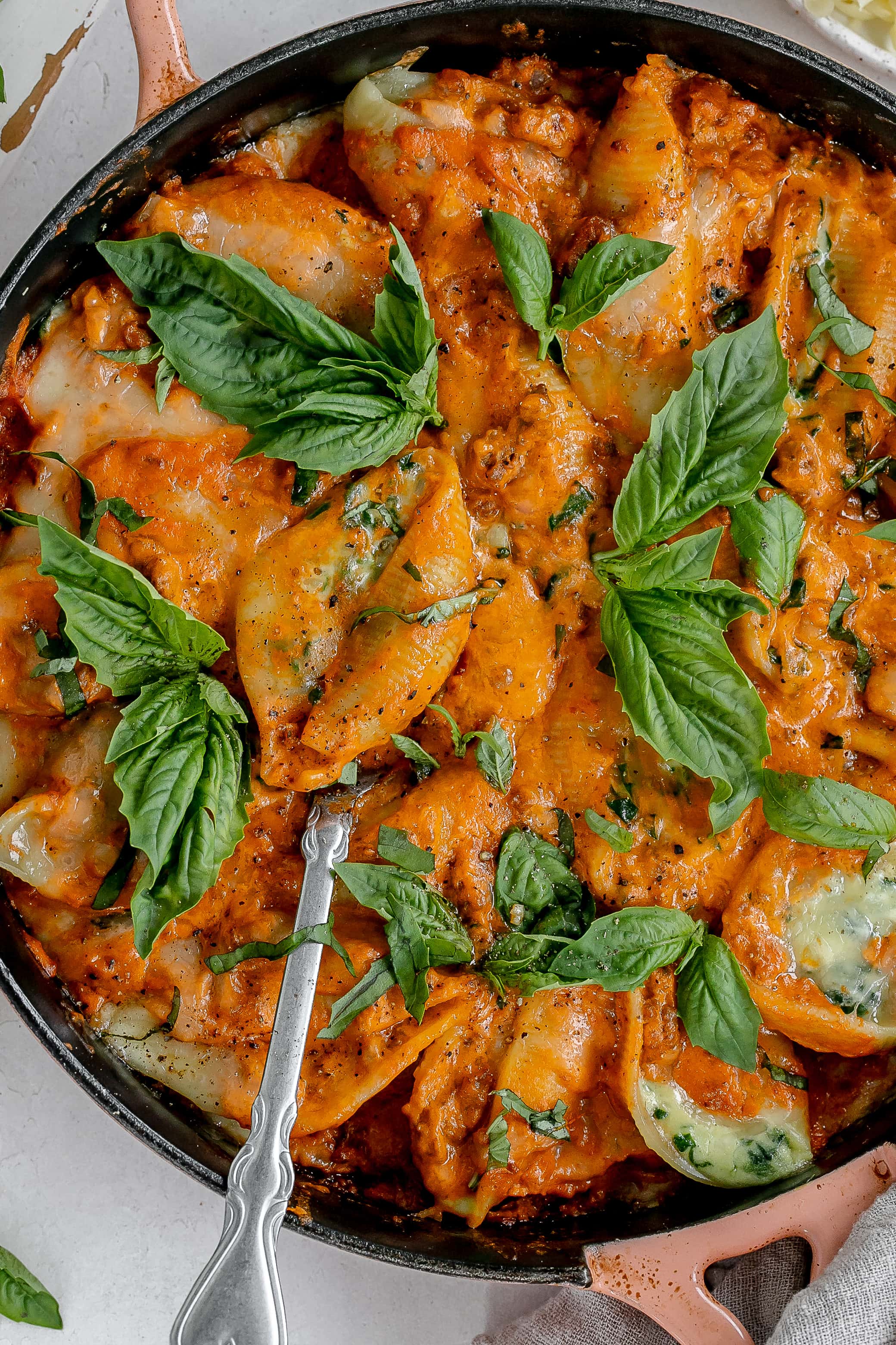 stuffed shells with vodka meat sauce in a cast iron pan.