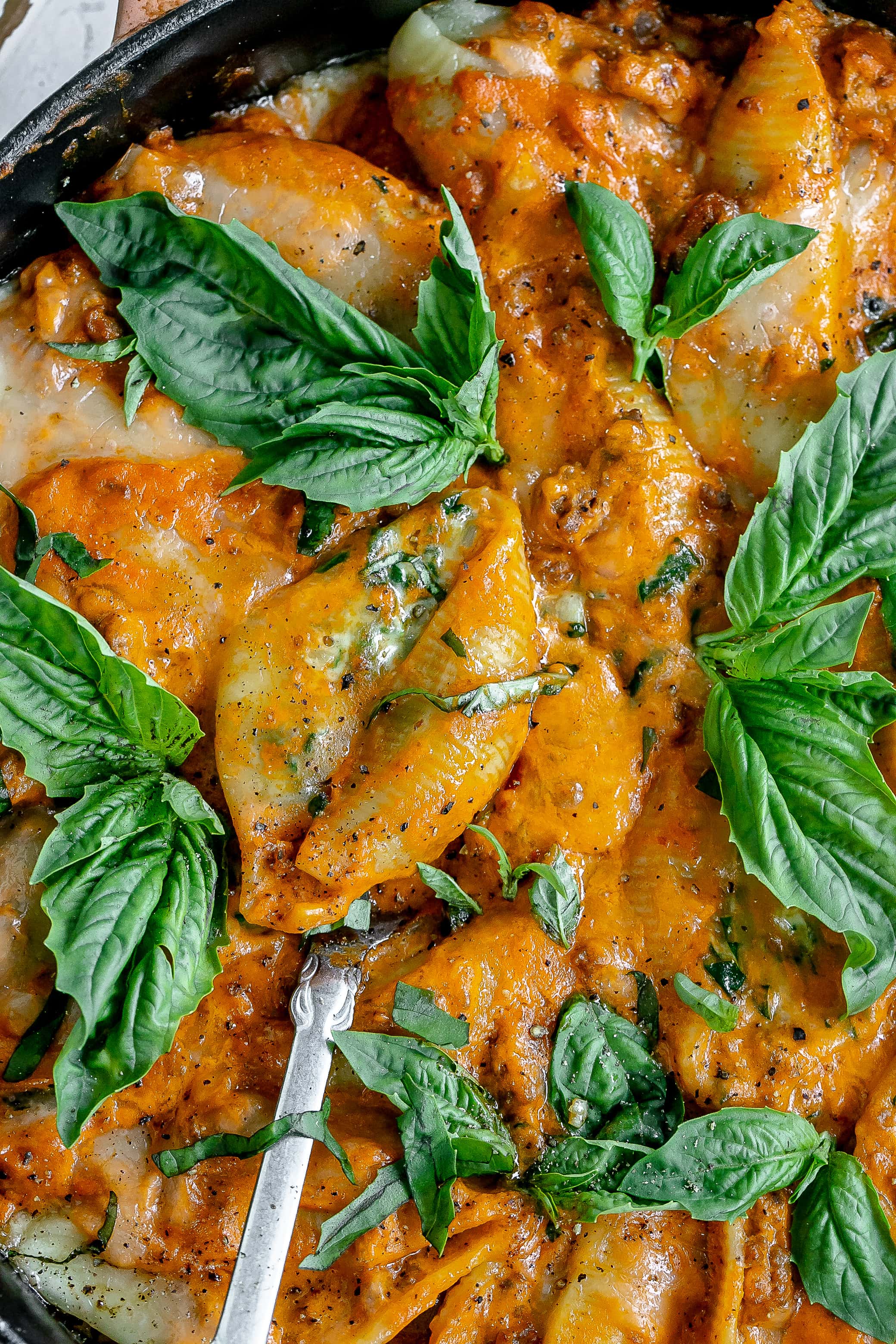 stuffed shells with vodka meat sauce in a cast iron pan.