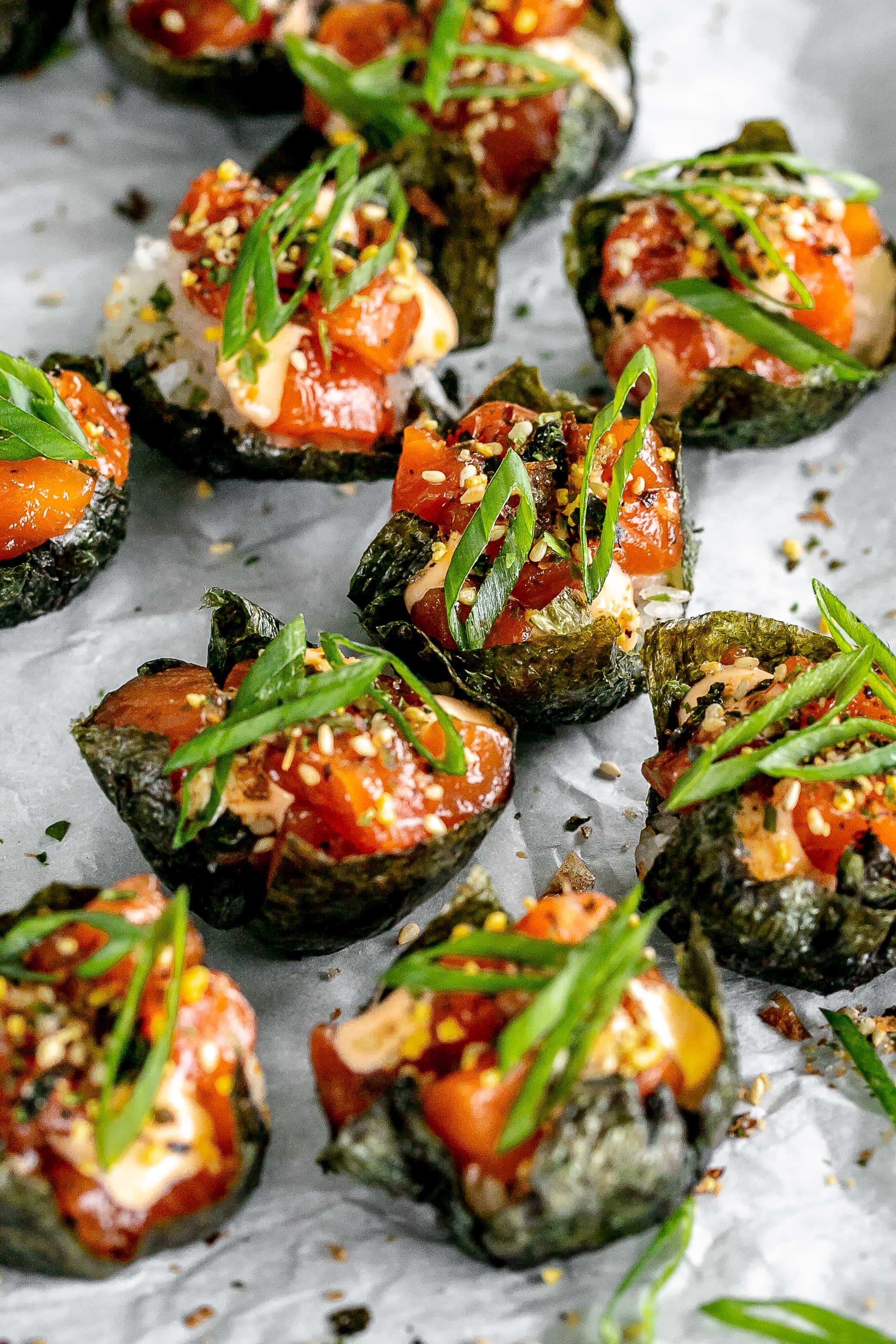 salmon sushi cups on a baking sheet with parchment paper. 