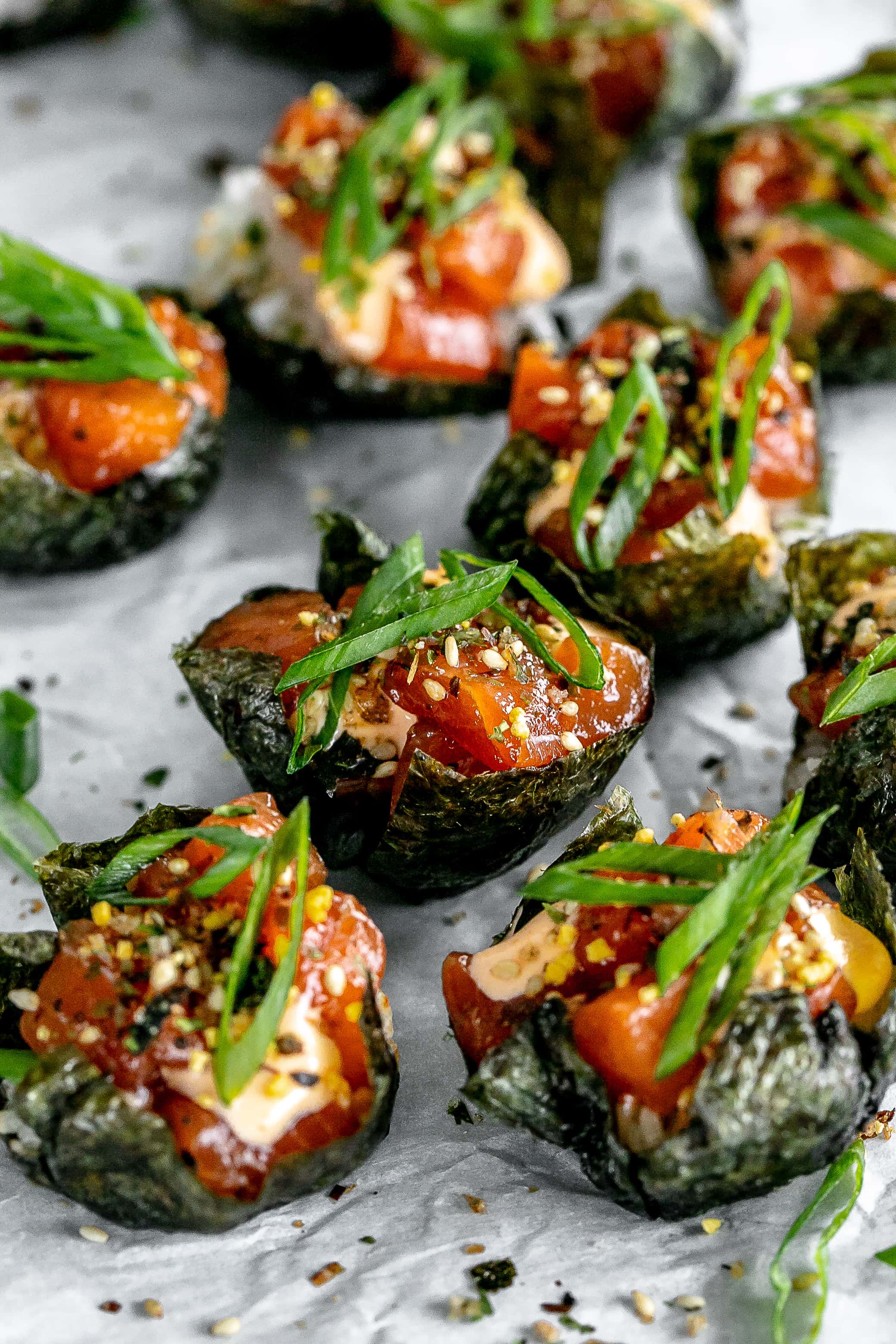 salmon sushi cups on a baking sheet with parchment paper. 