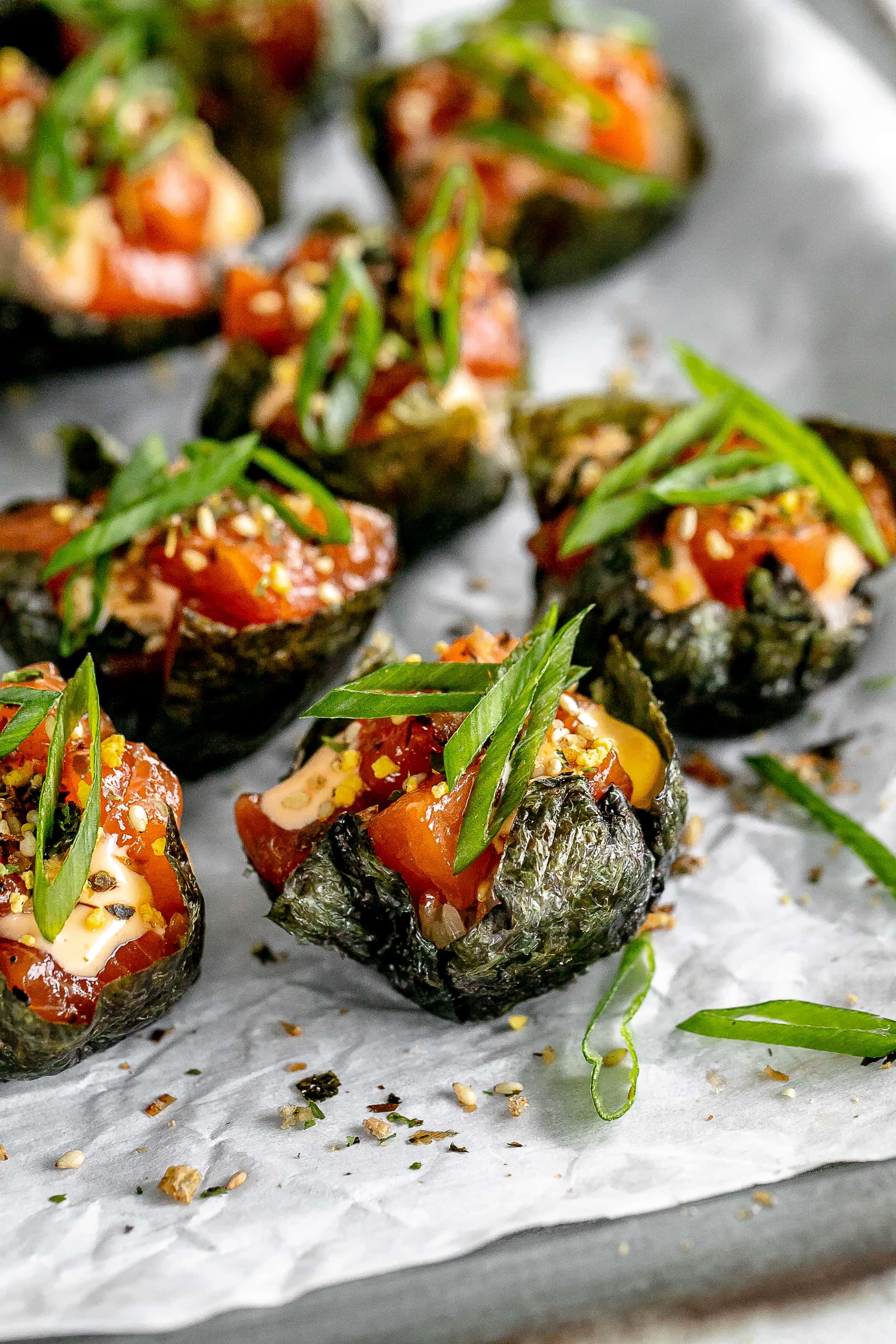 salmon sushi cups on a baking sheet with parchment paper. 