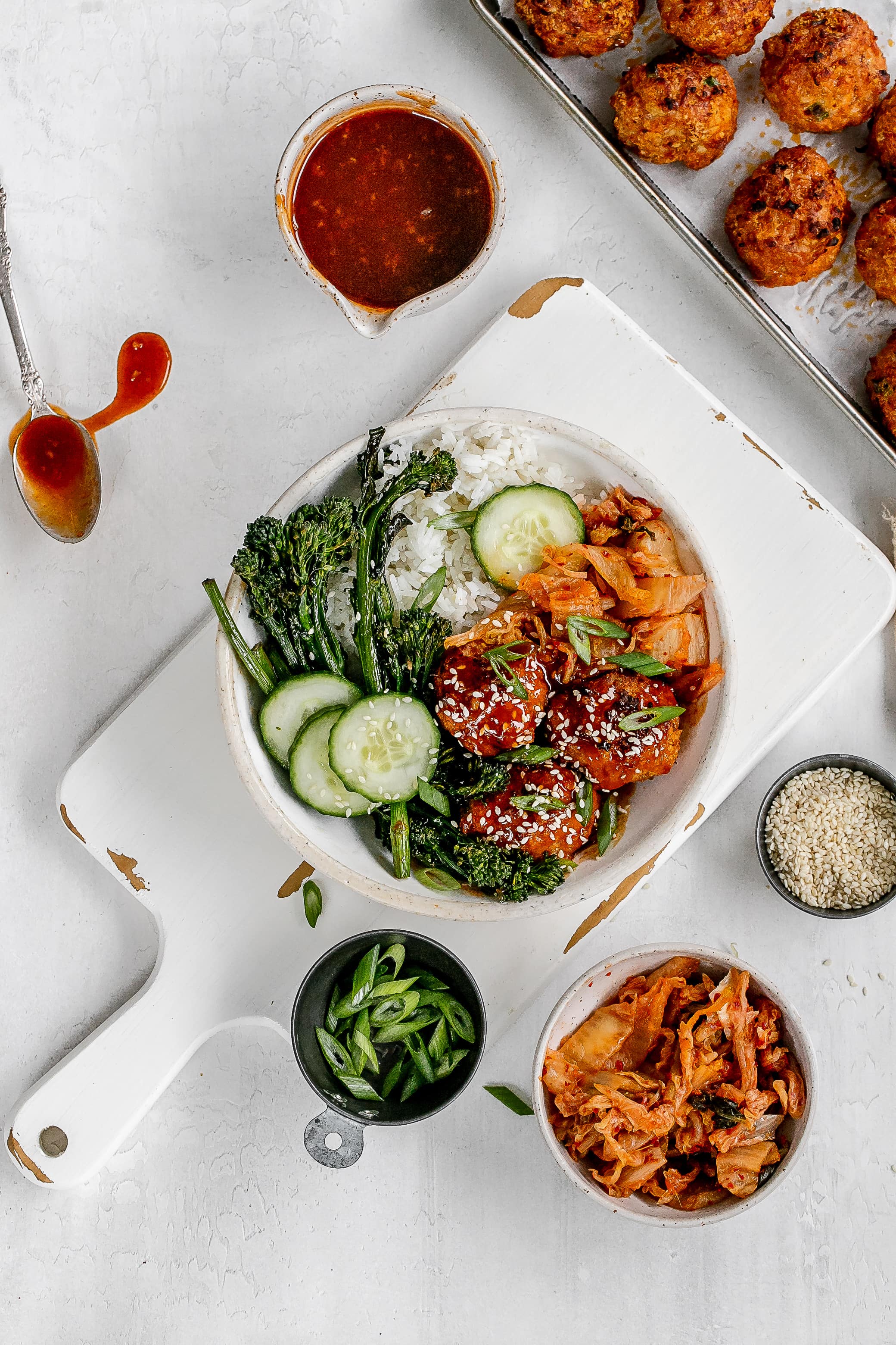 gochujang meatballs in a bowl with rice, veggies and kimchi.
