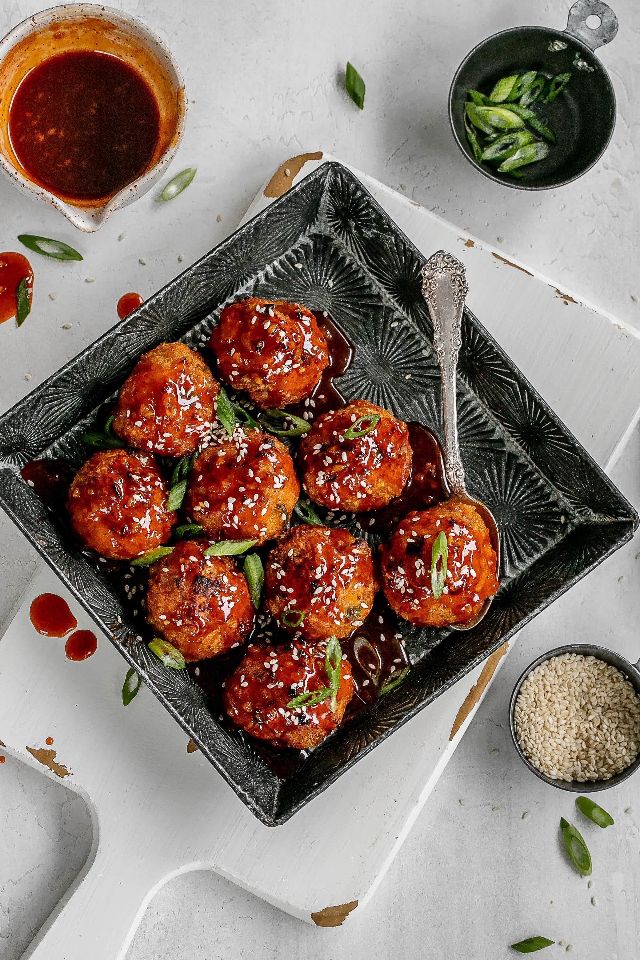 gochujang meatballs on a serving tray with sauce.