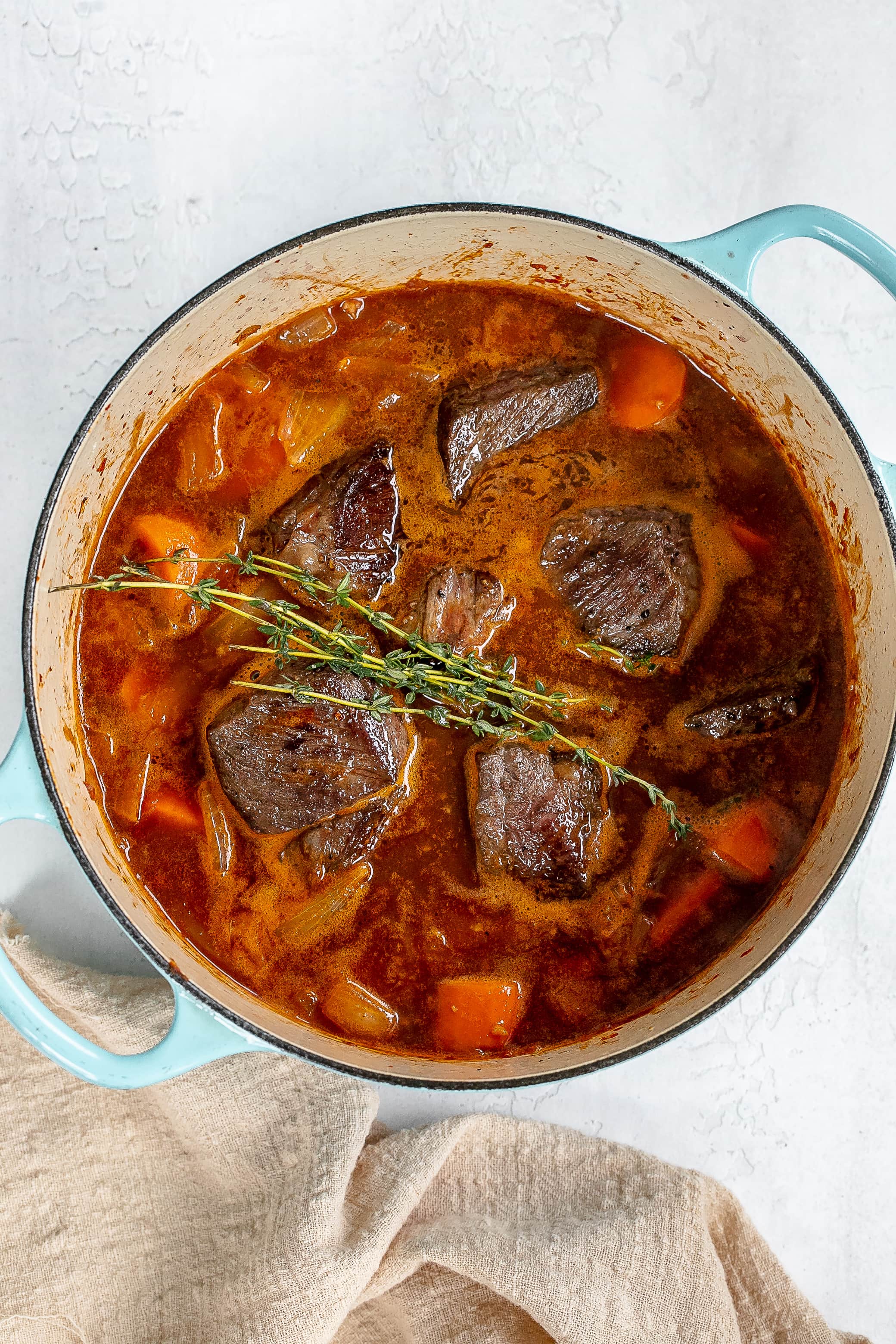 short ribs and thyme added to pot.