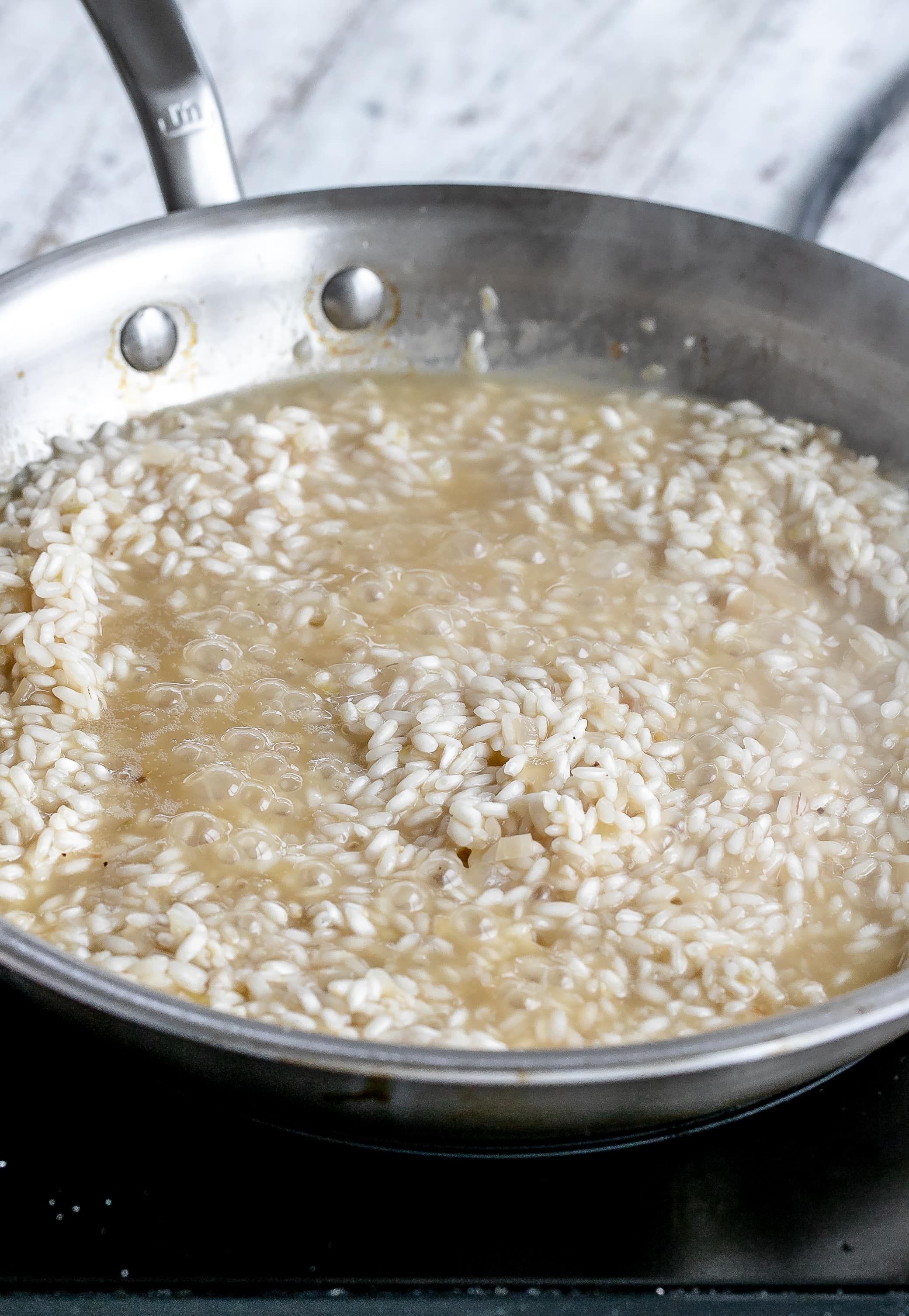 risotto cooking in skillet.