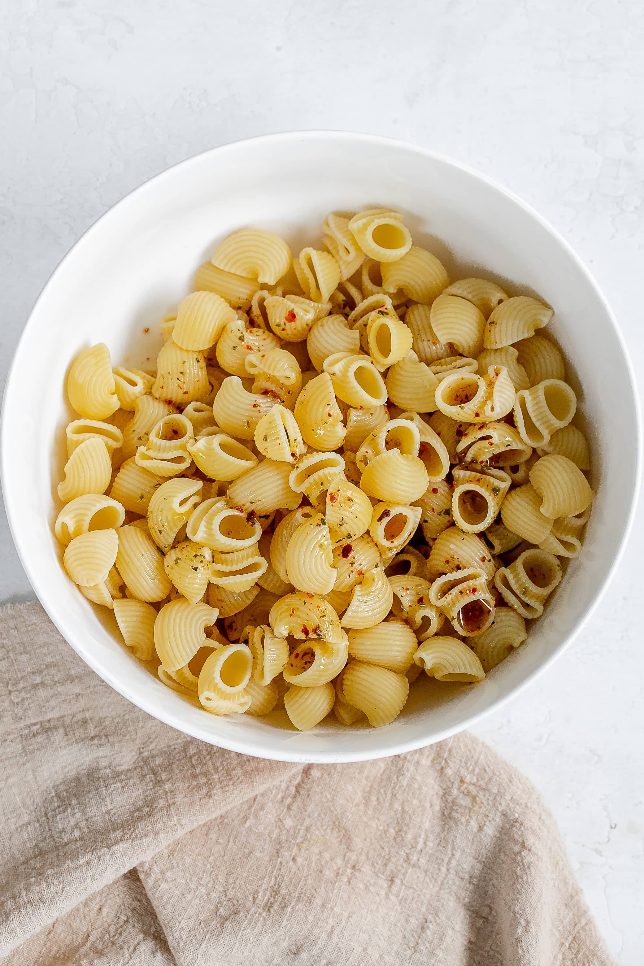 macaroni in large bowl with dressing.