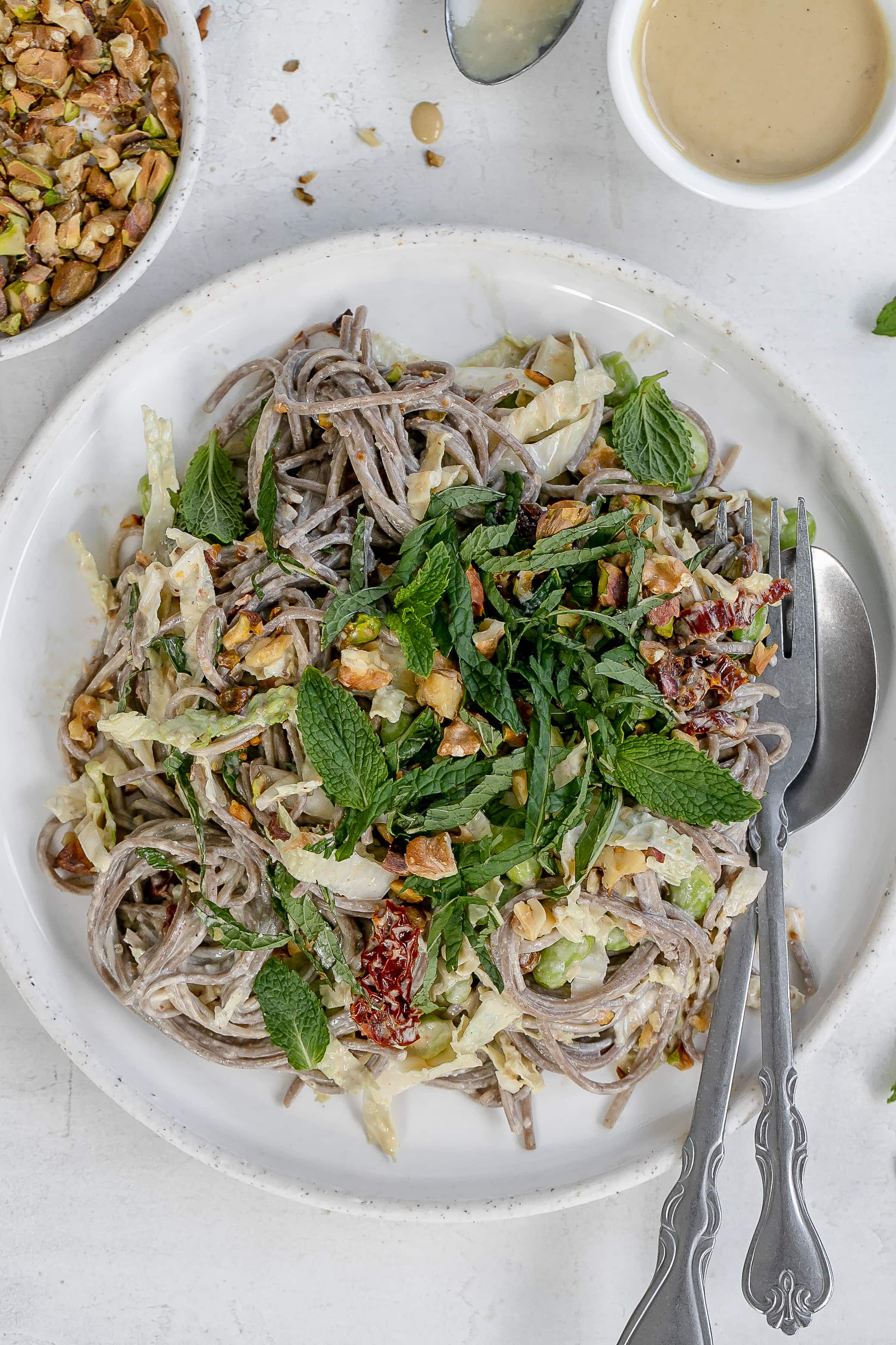 vegan soba noodle salad with sesame dressing on a plate. 