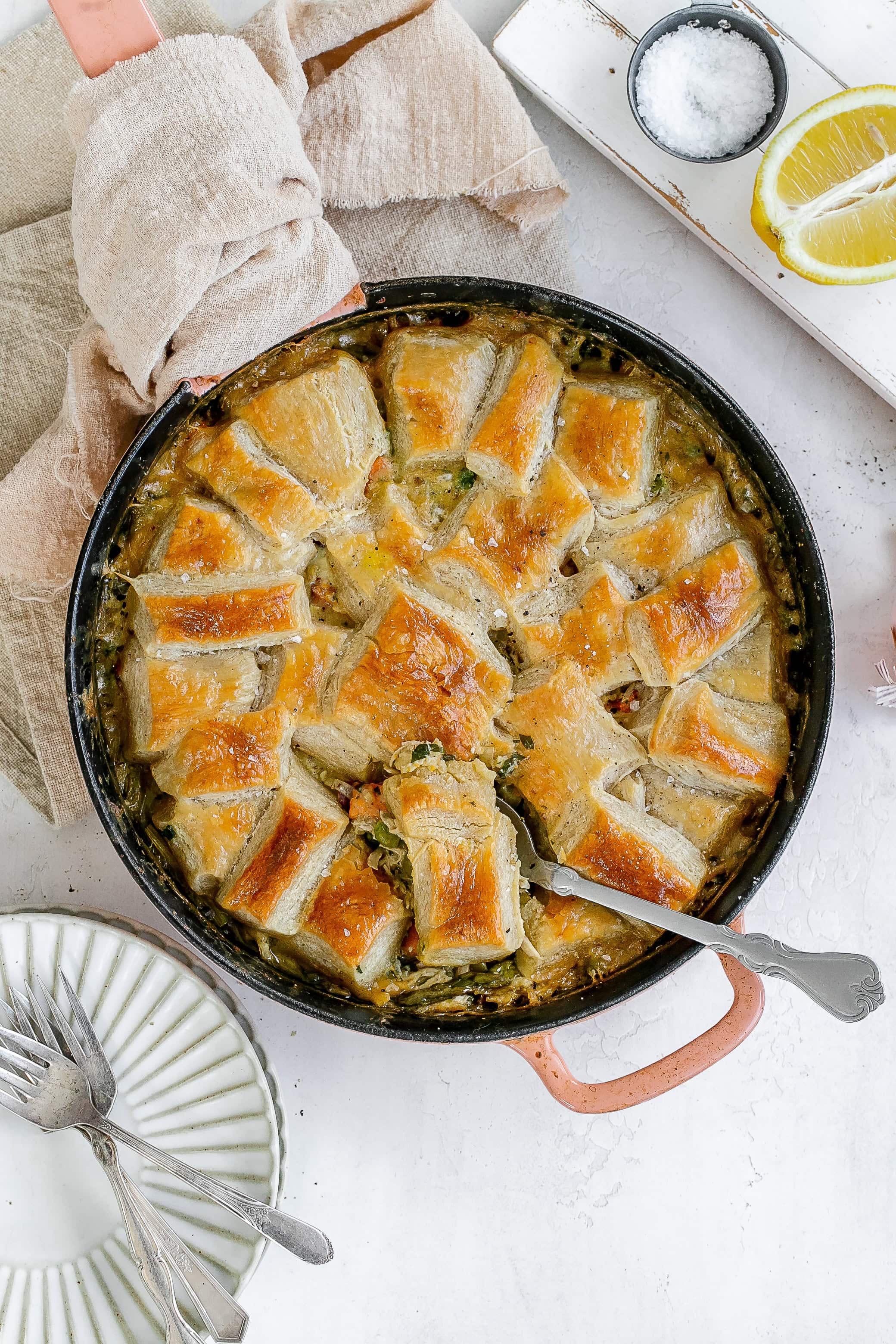 cast iron chicken pot pie with spoon digging in. 