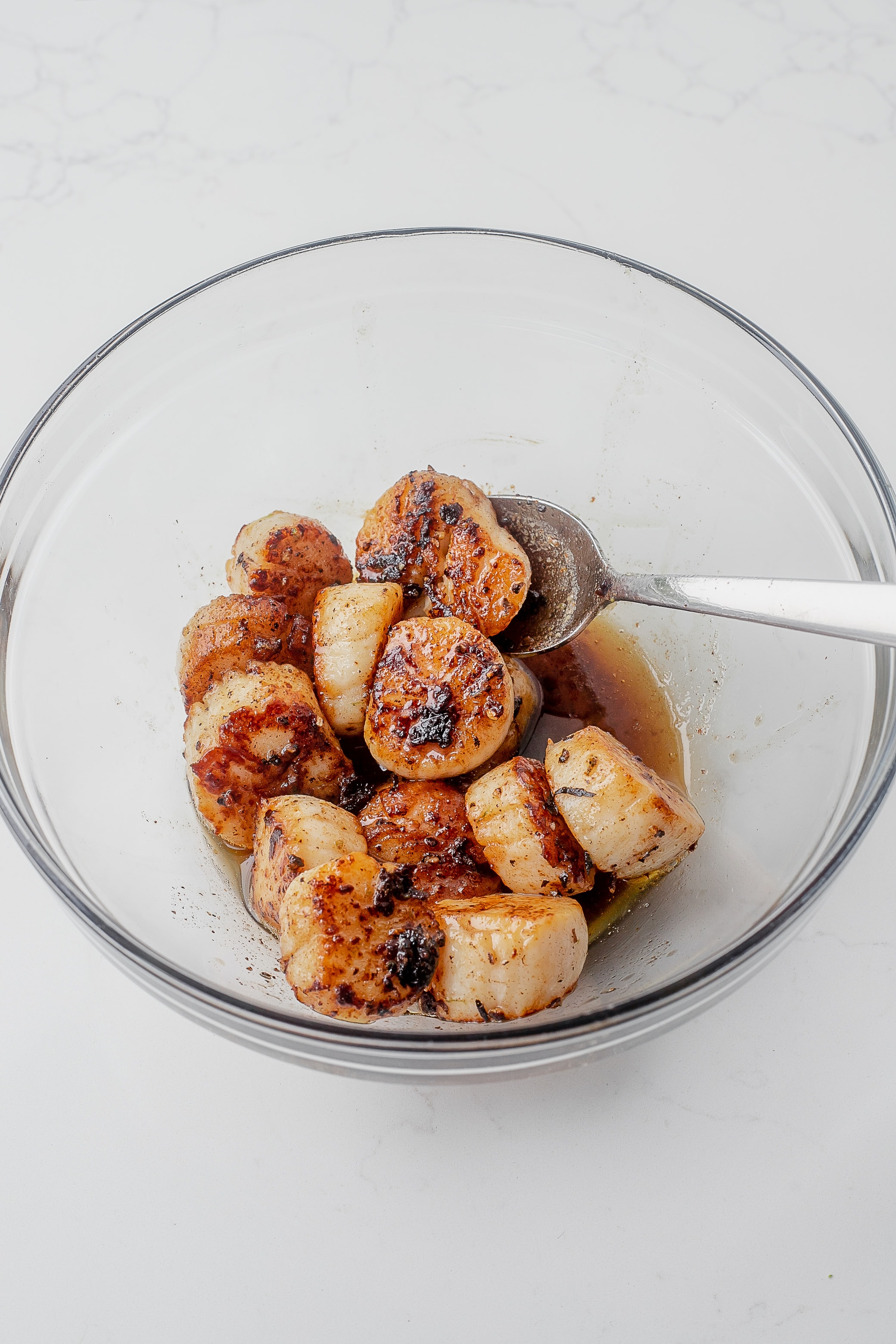 seared scallops in bowl with melted butter.