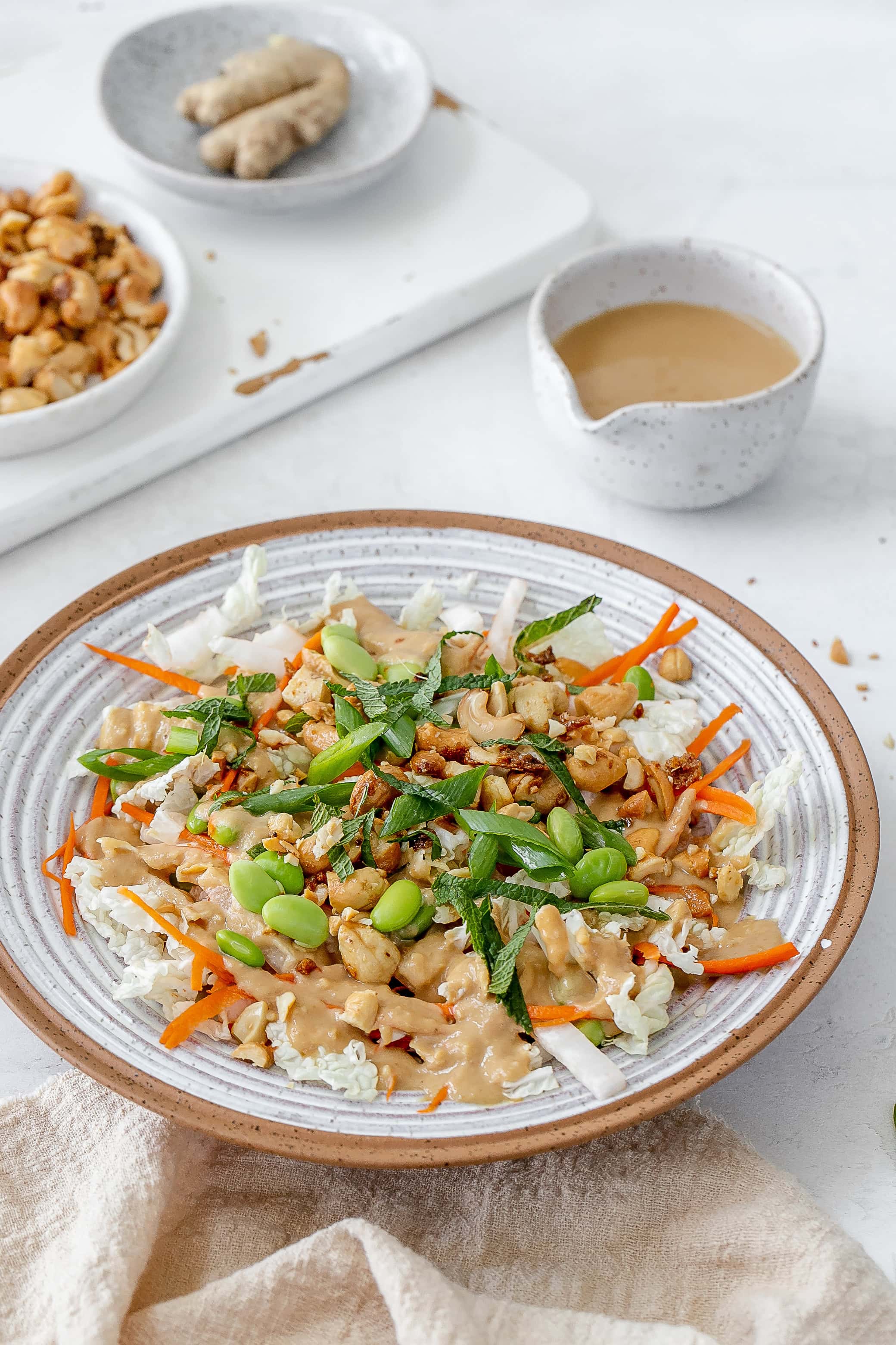 miso slaw in bowl with dressing on the side. 